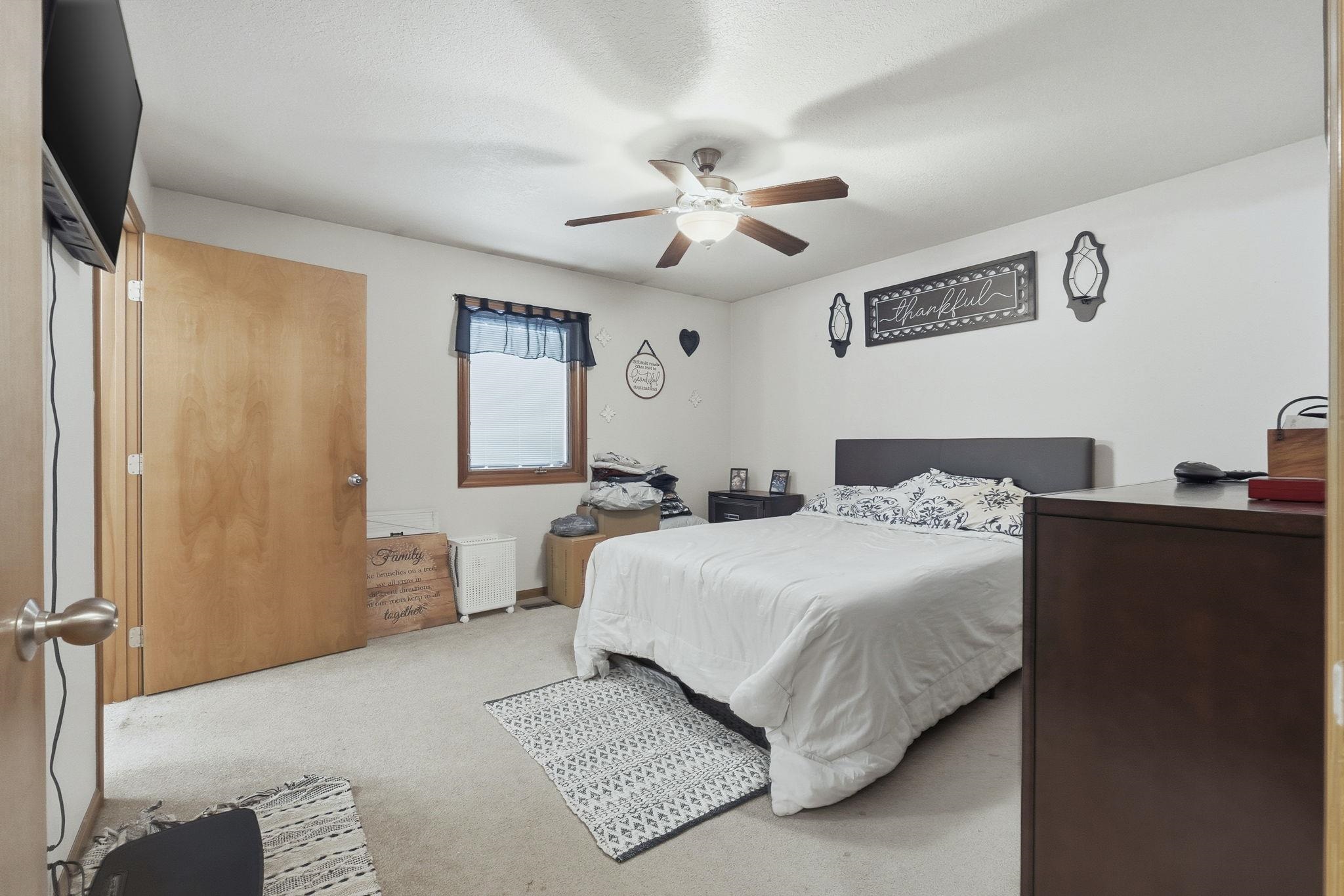 Bedroom featuring ceiling fan and carpet