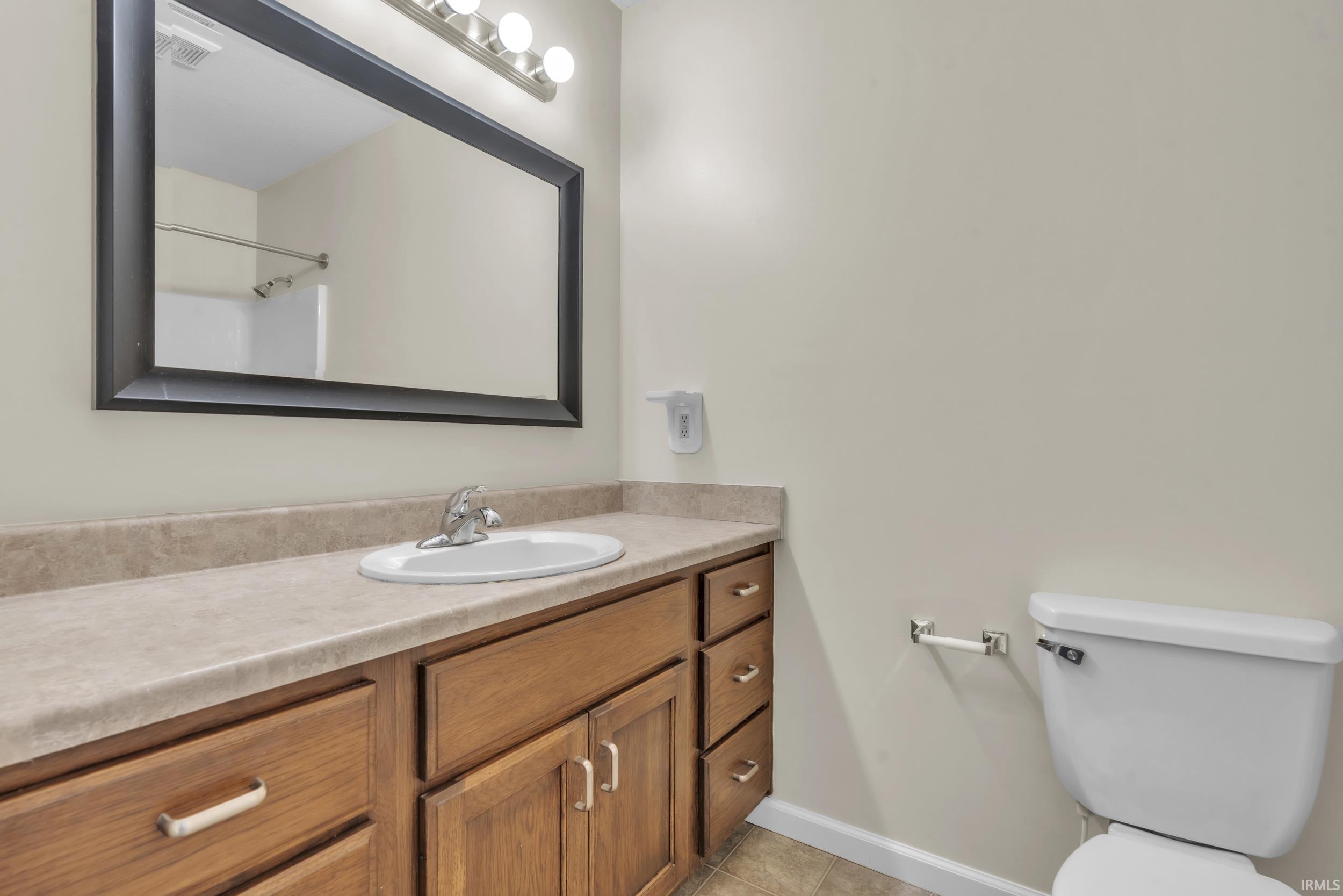 Bathroom featuring vanity and light tile patterned floors