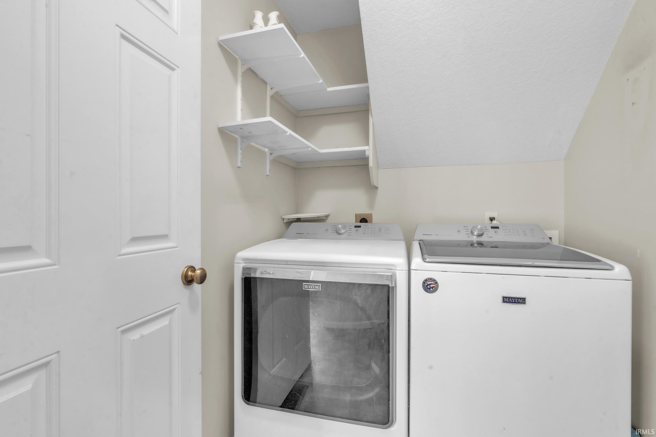 Washroom featuring separate washer and dryer and a textured ceiling