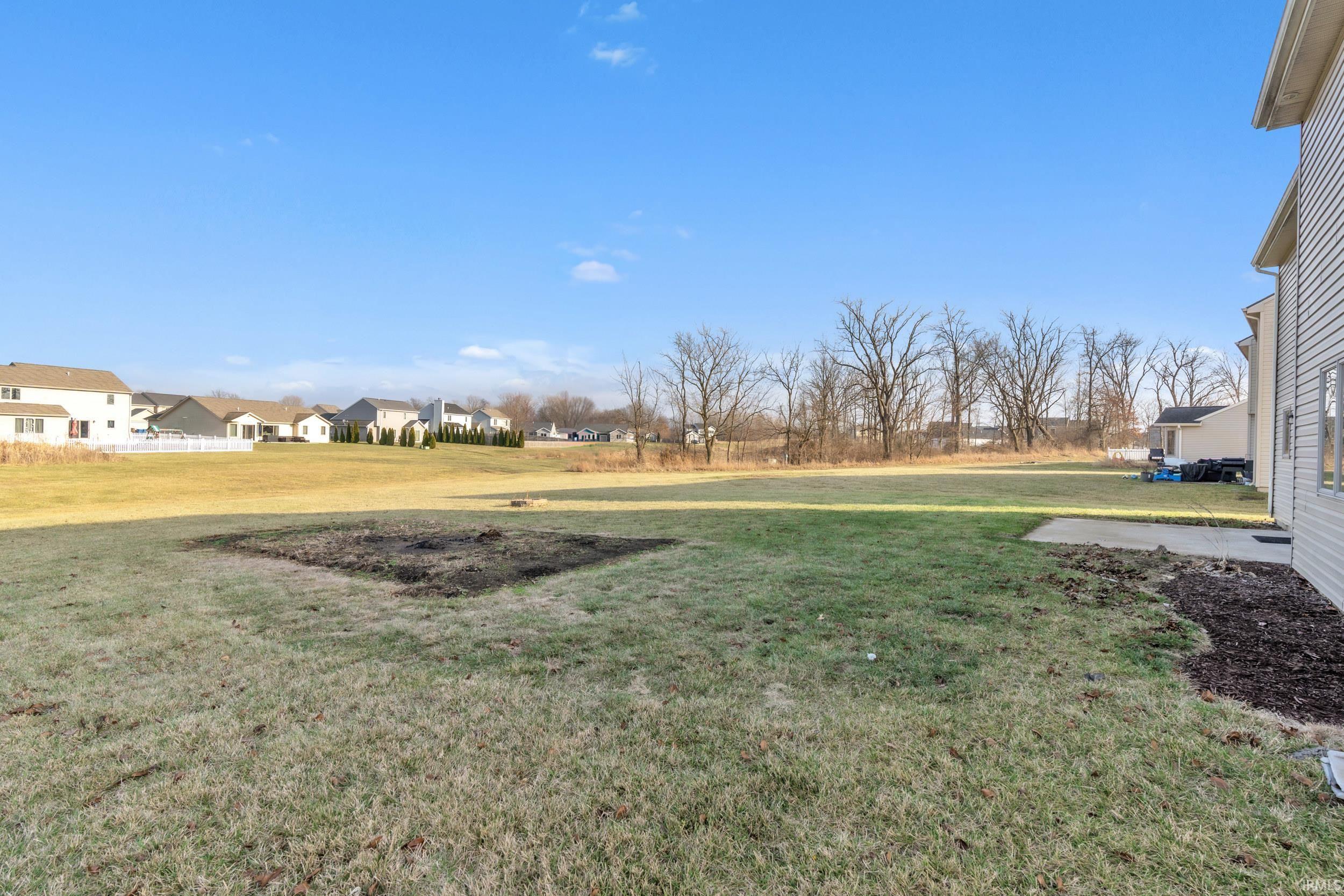 View of green lawn featuring a residential view
