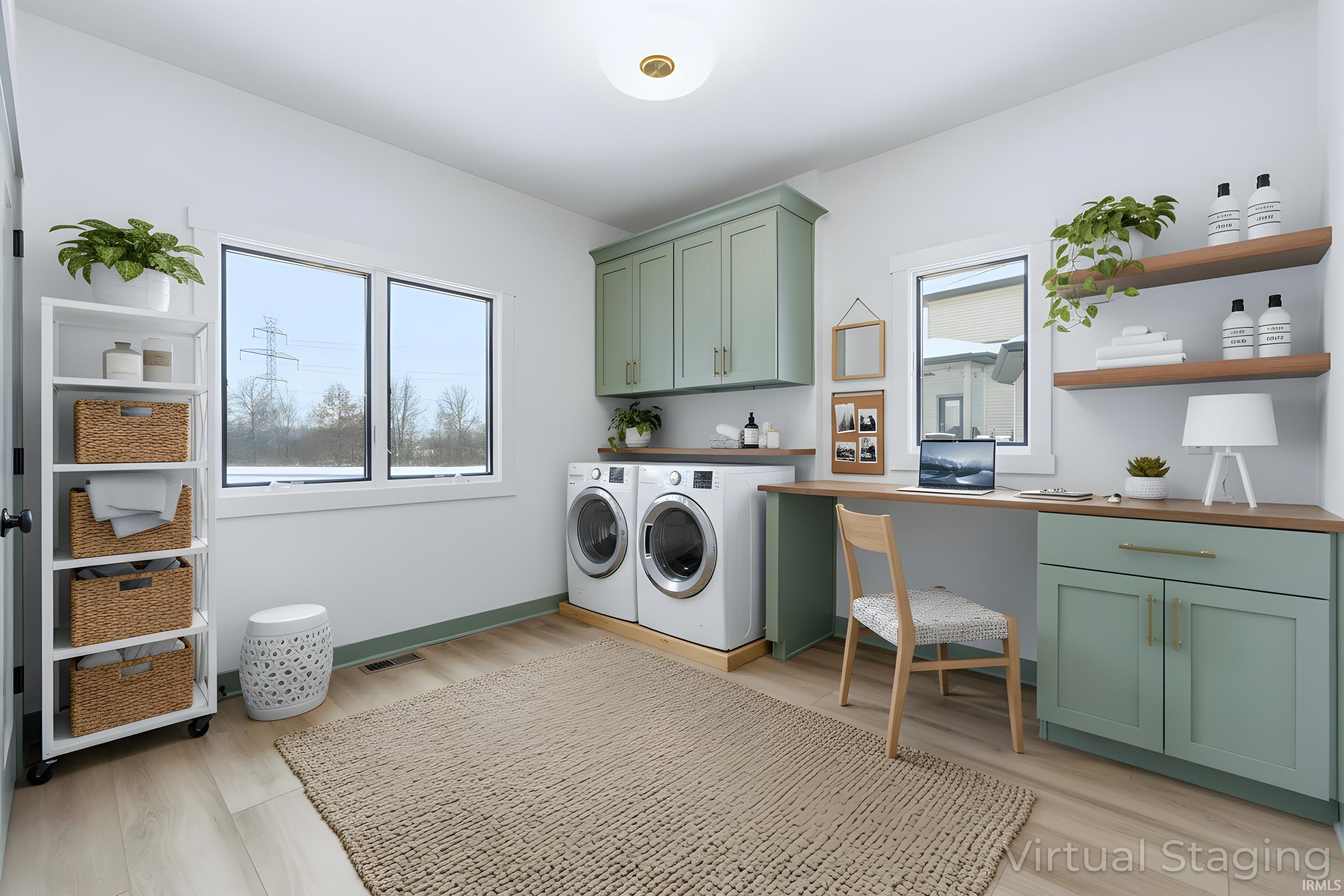 Laundry room featuring washing machine and clothes dryer, cabinet space, and light wood-style flooring