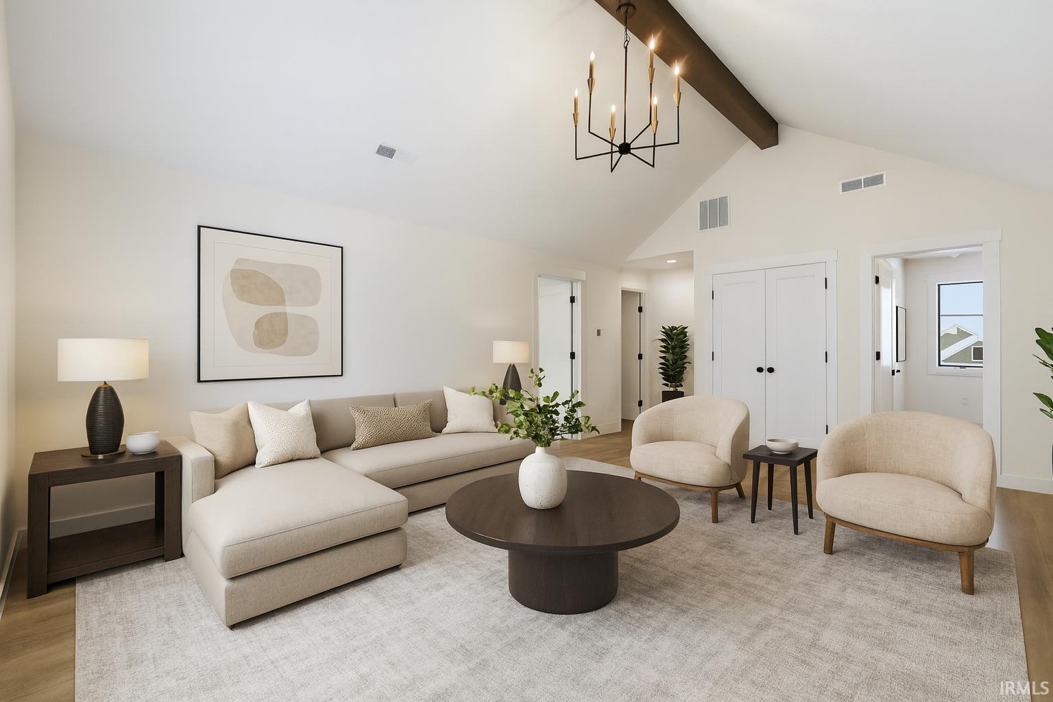 Living area featuring light wood finished floors, a chandelier, beamed ceiling, and high vaulted ceiling