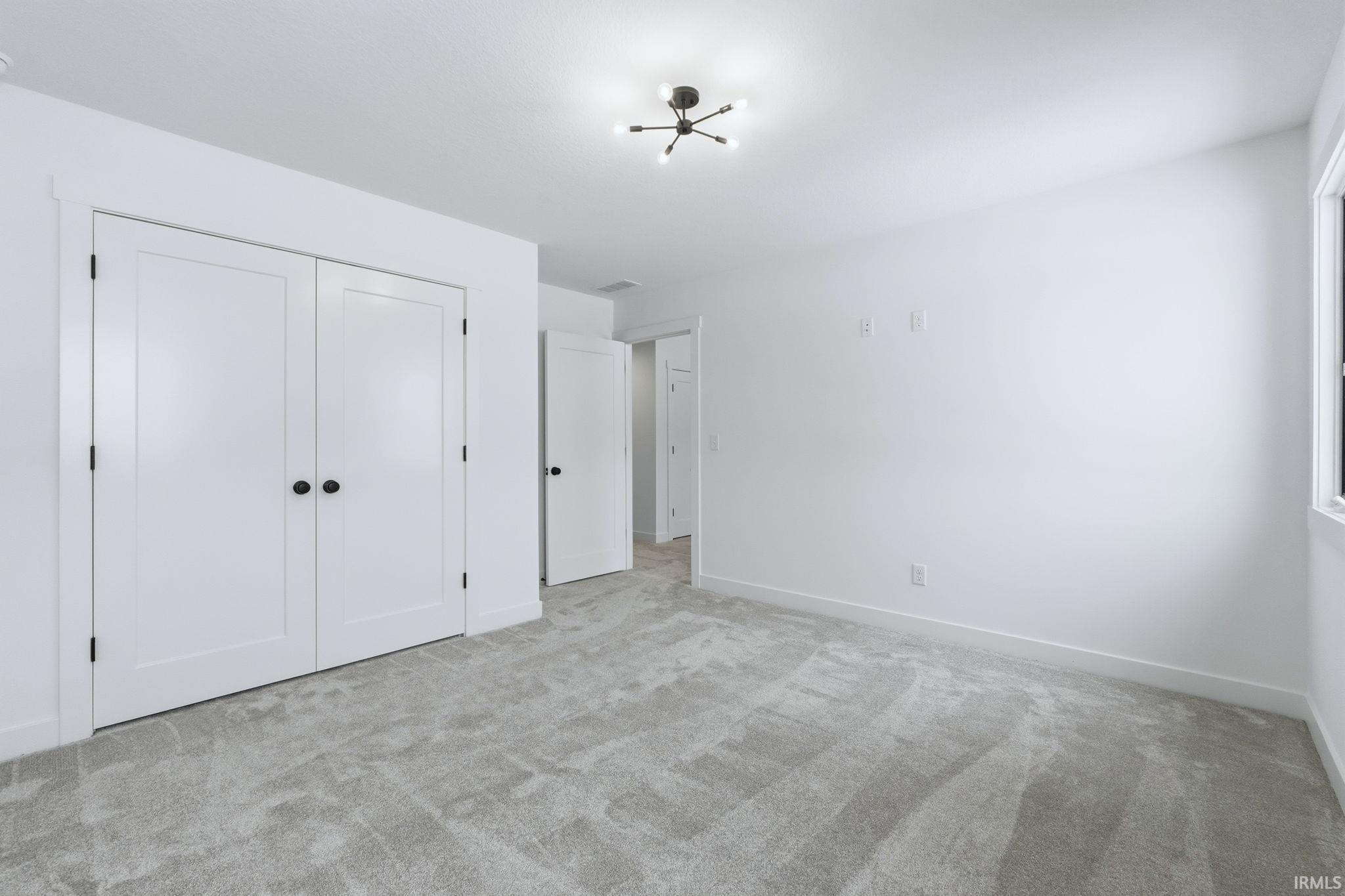 Unfurnished bedroom featuring carpet floors and a closet