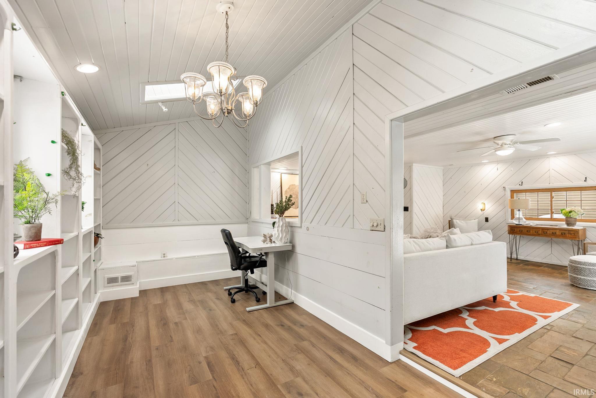 Office space with wood walls, recessed lighting, wood ceiling, wood finished floors, and a chandelier