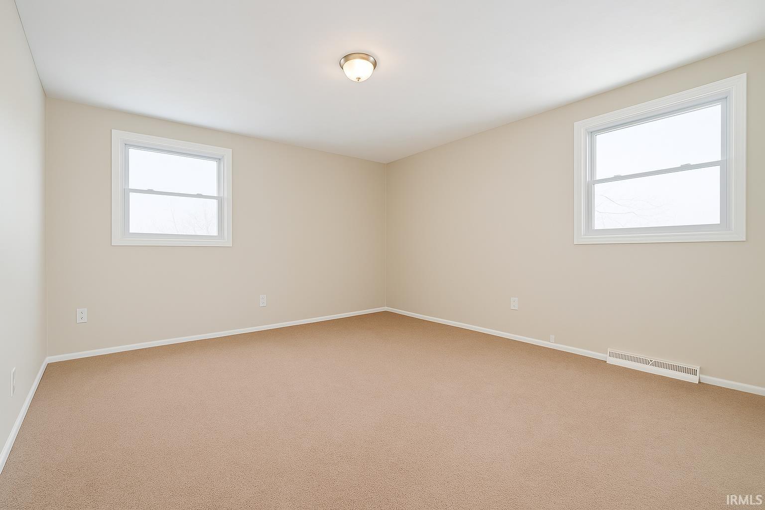 Unfurnished room with carpet flooring and healthy amount of natural light