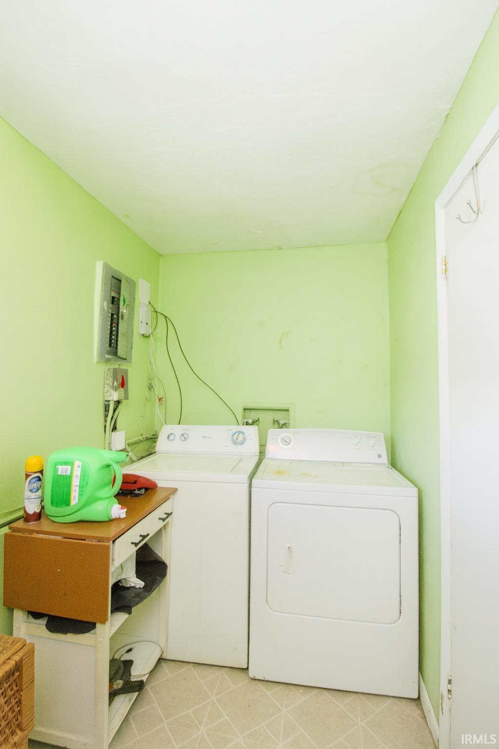 Laundry area with washer and dryer and electric panel