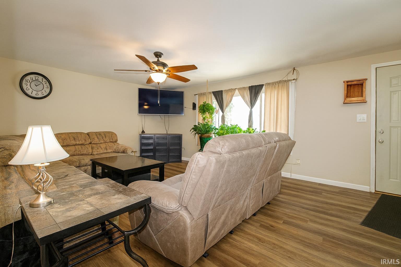 Living room with wood finished floors and ceiling fan