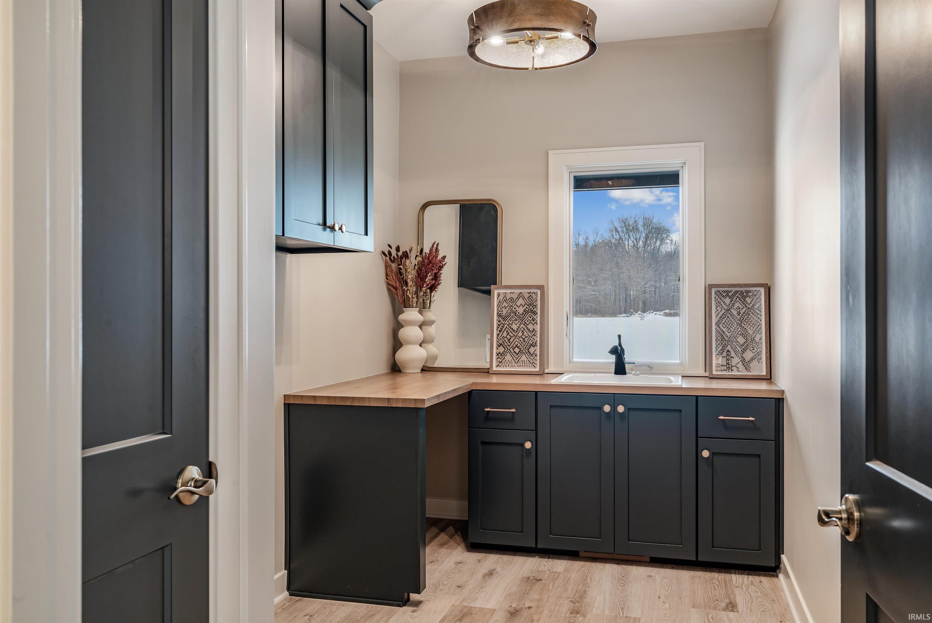 Bar area featuring light wood-type flooring and butcher block counters