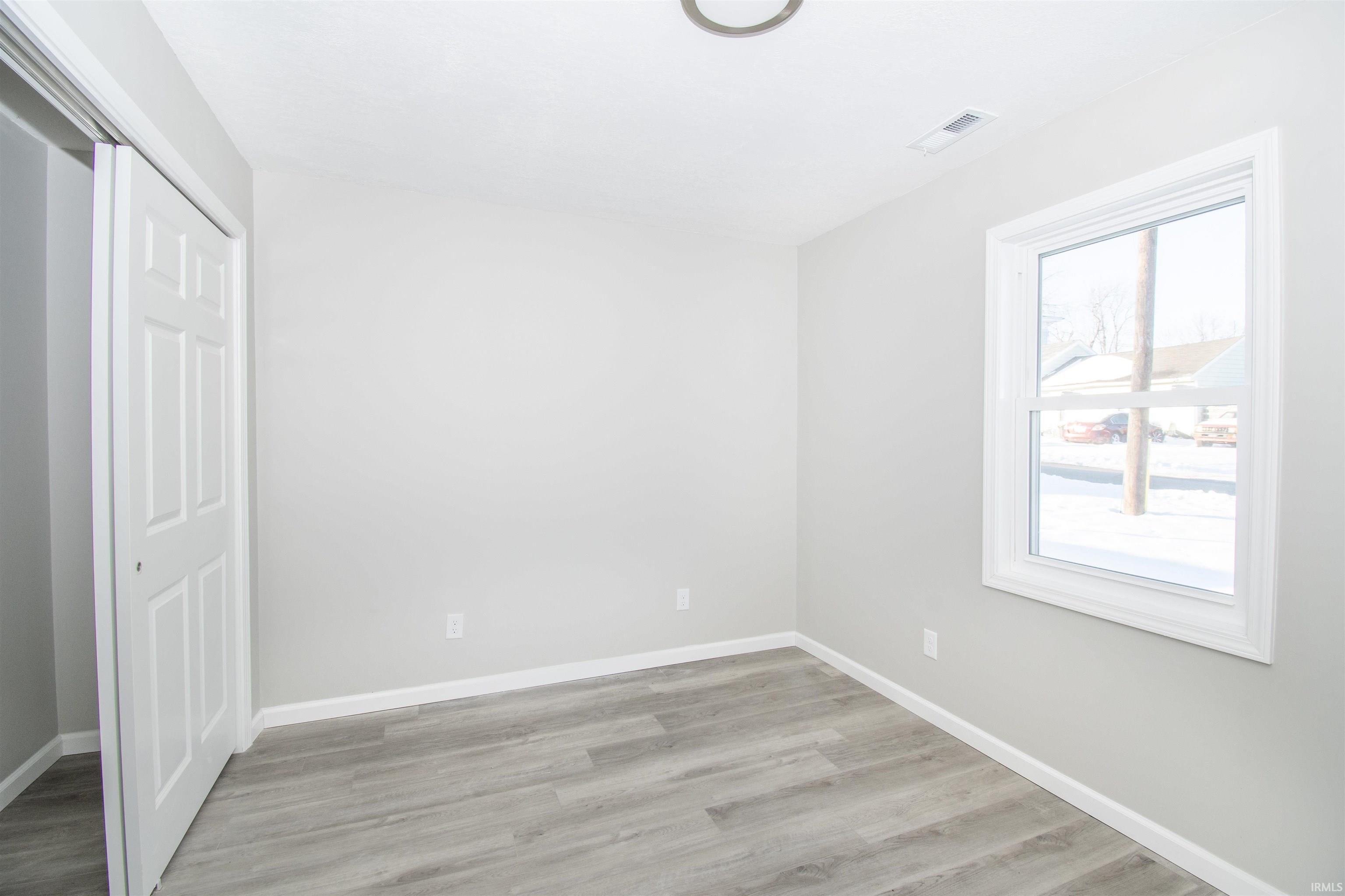 Unfurnished bedroom featuring a closet and light wood-style floors