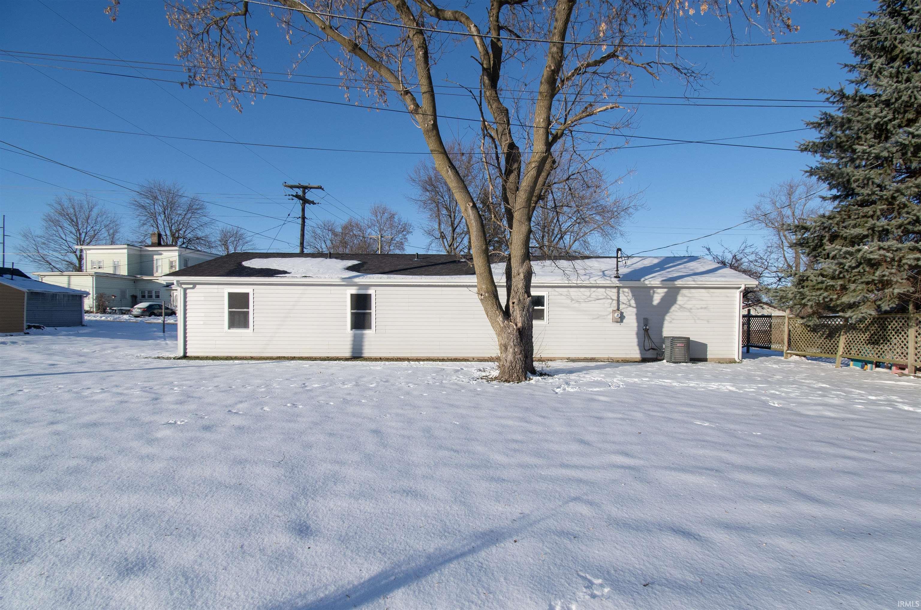 View of snow covered back of property