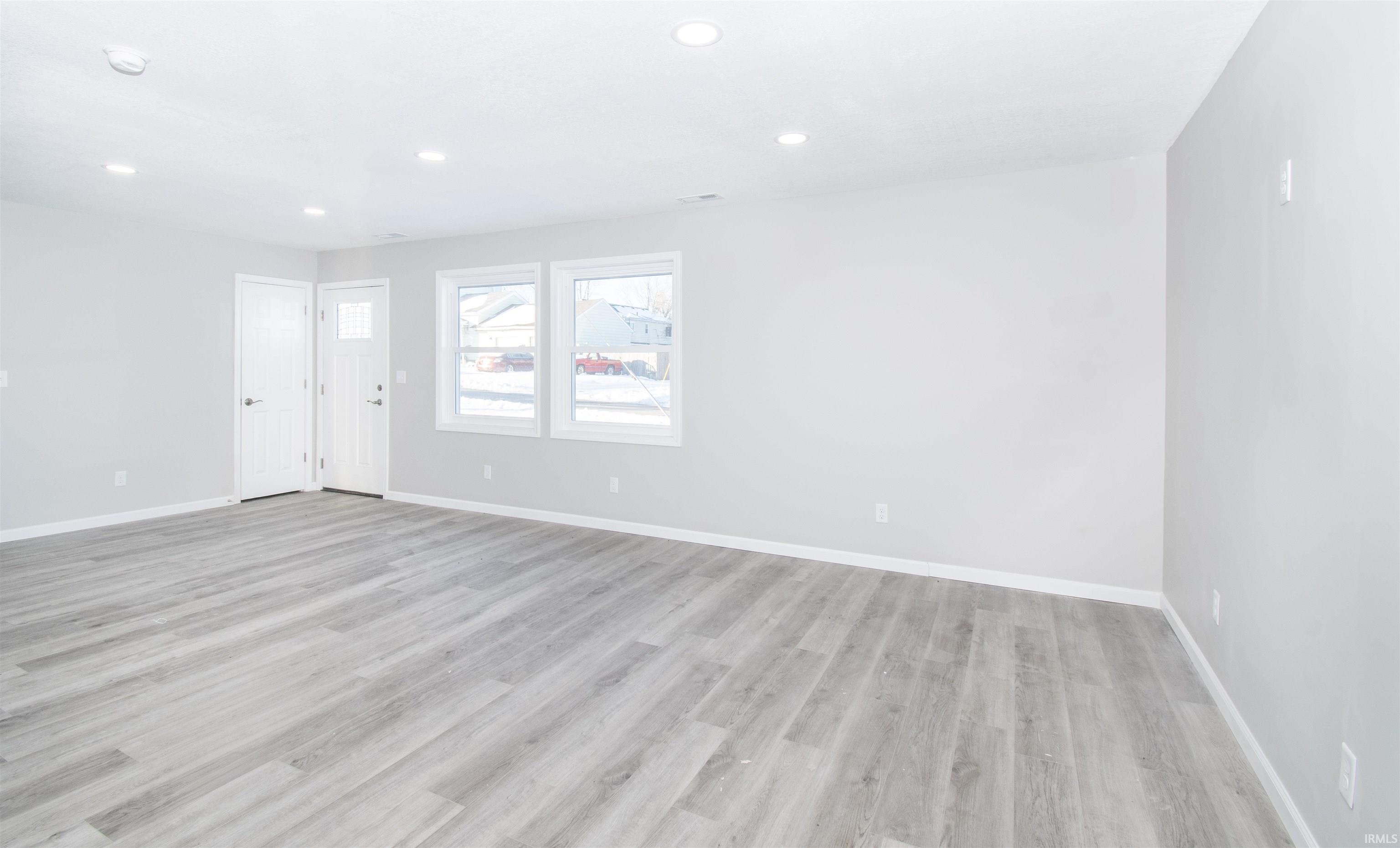 Empty room featuring recessed lighting and light wood-style flooring