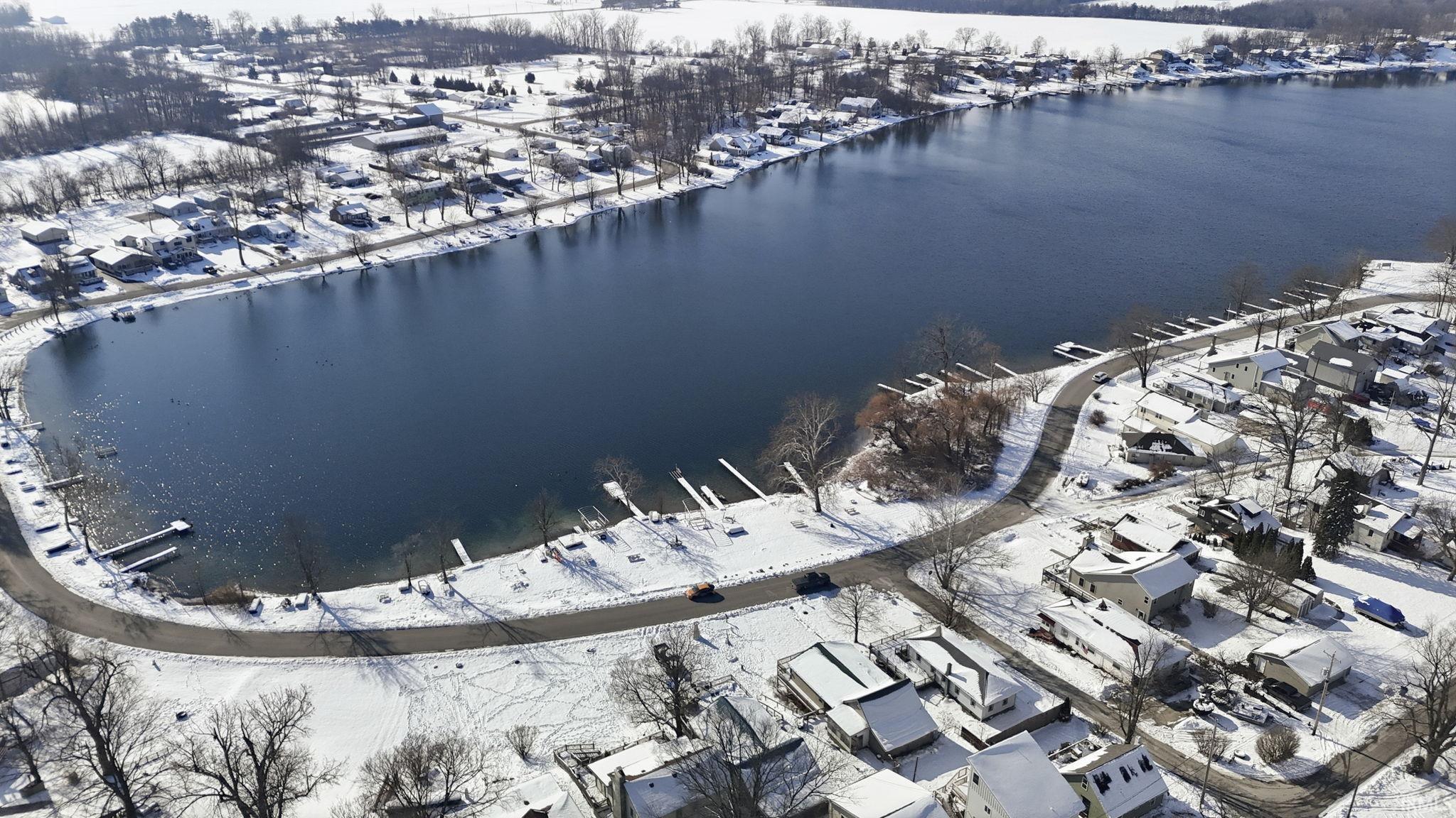 Aerial view of property and surrounding area with a large body of water