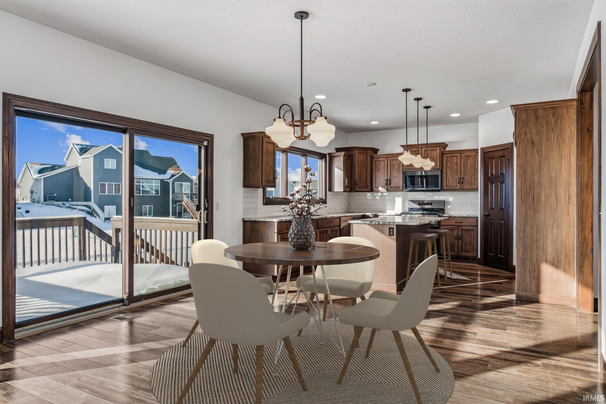 Dining area with light wood-type flooring and recessed lighting