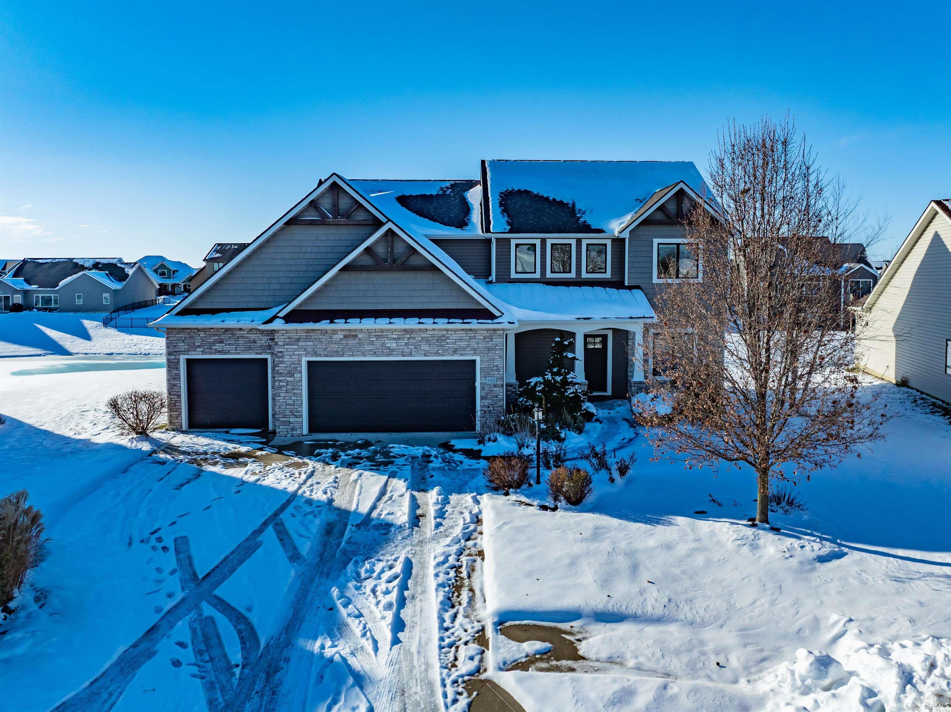 Craftsman house featuring a garage and stone siding