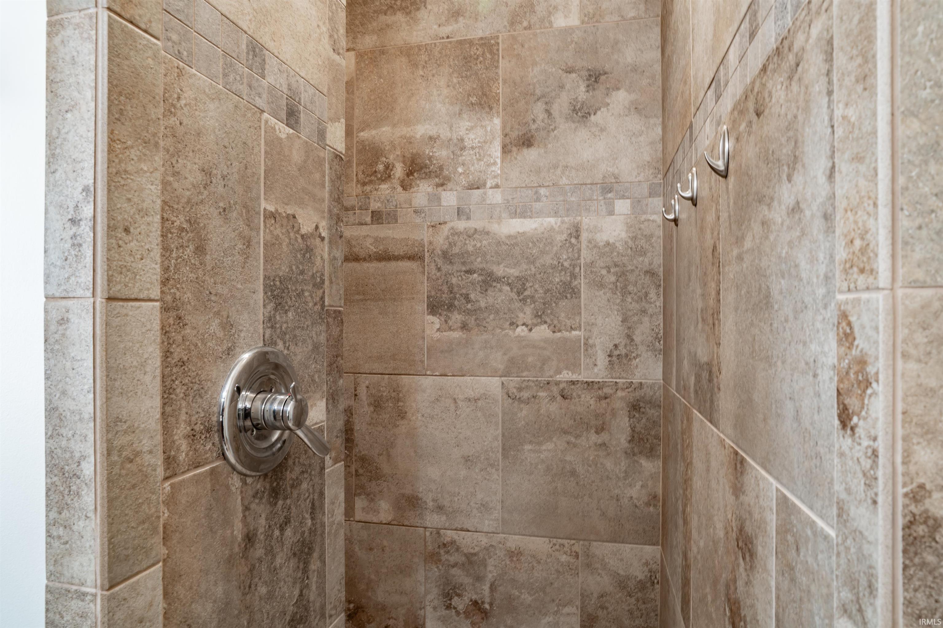 Bathroom view of a tile shower