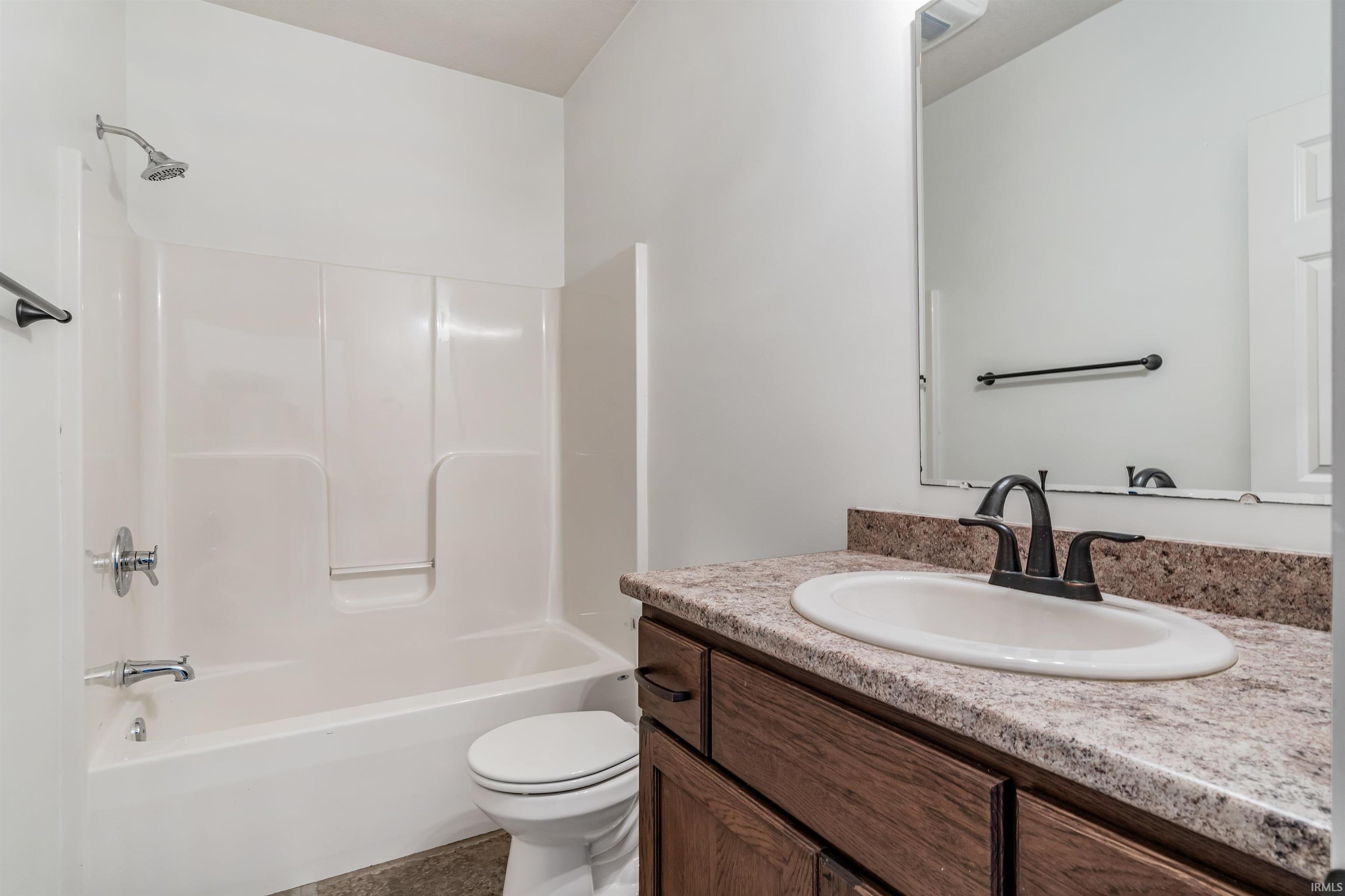 Full bath featuring vanity and  shower combination