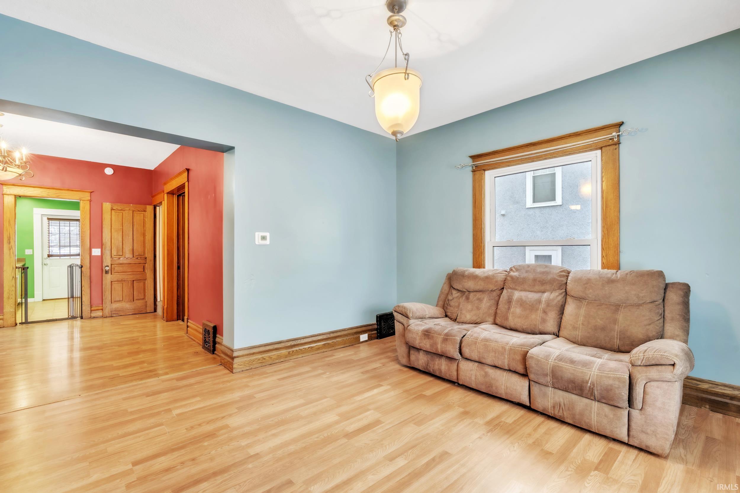 Living room featuring wood finished floors and a chandelier