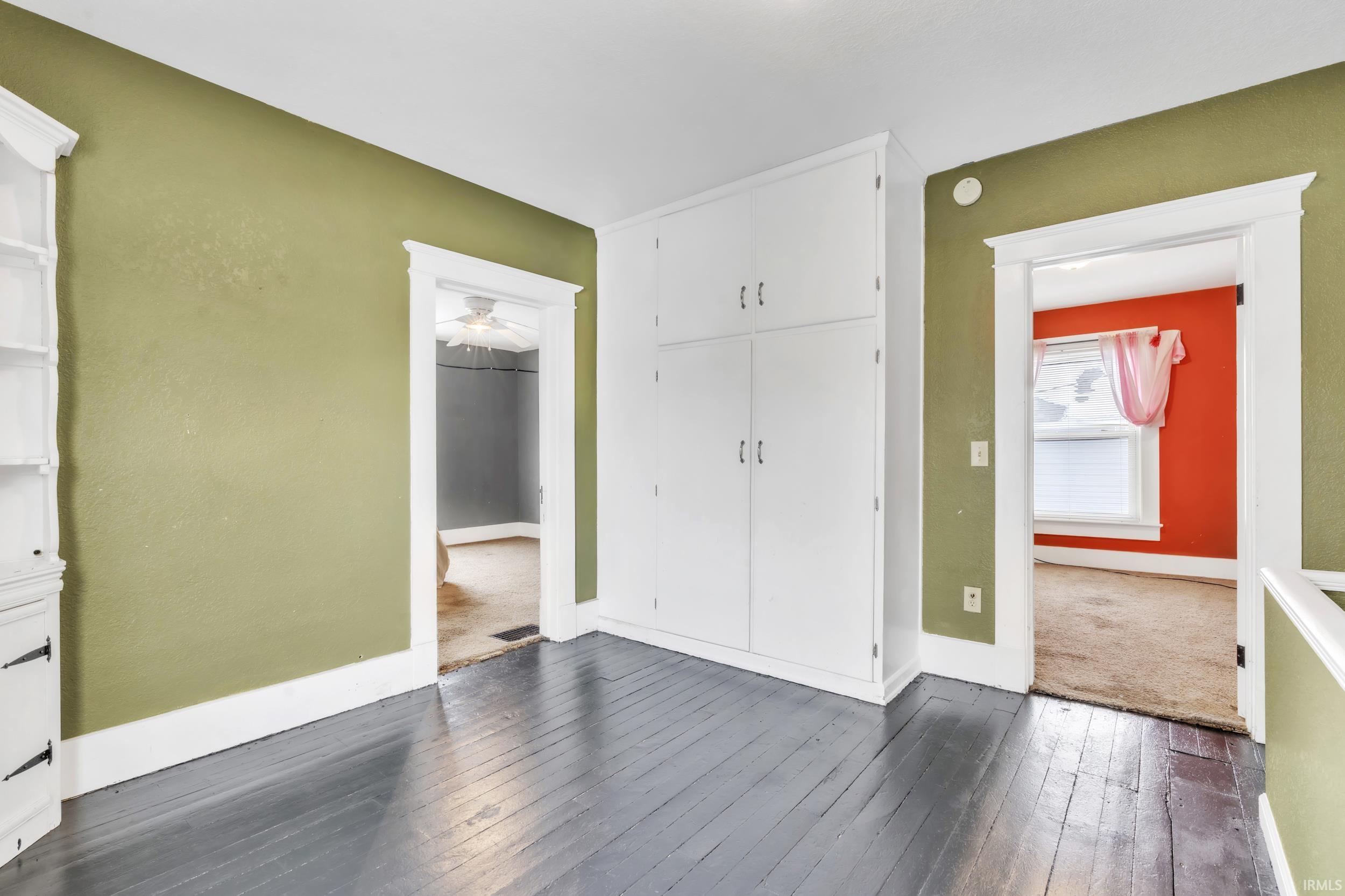 Entrance foyer featuring dark wood-type flooring and baseboards