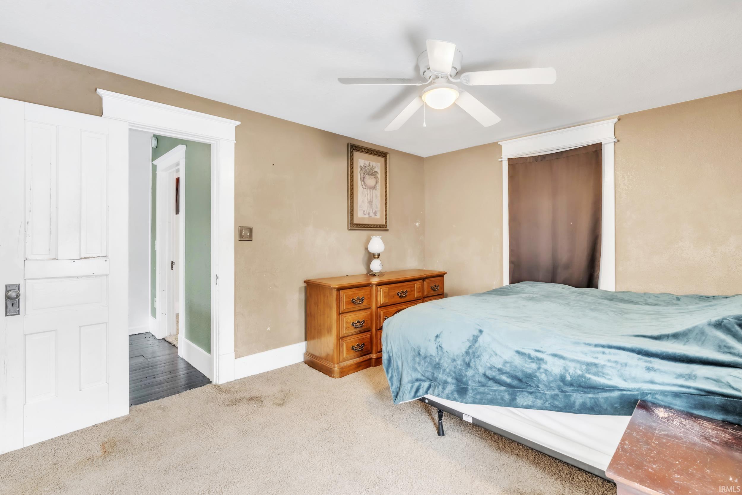 Bedroom with carpet flooring and a ceiling fan