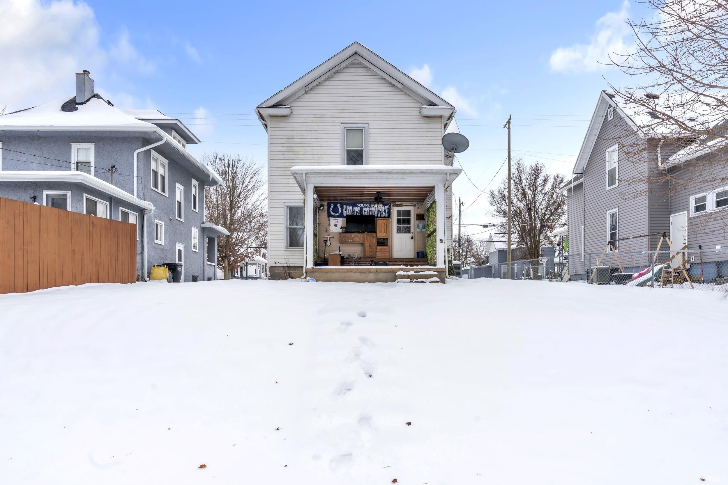 Back of property featuring a porch