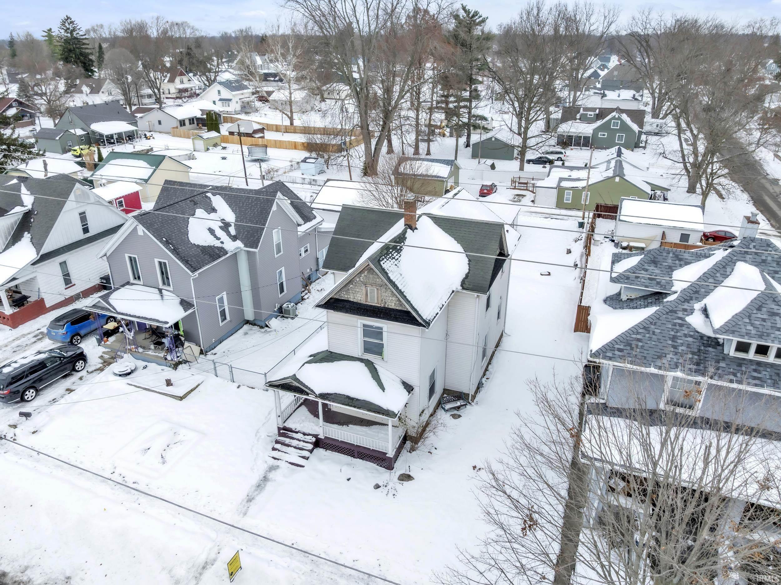Snowy aerial view featuring a residential view