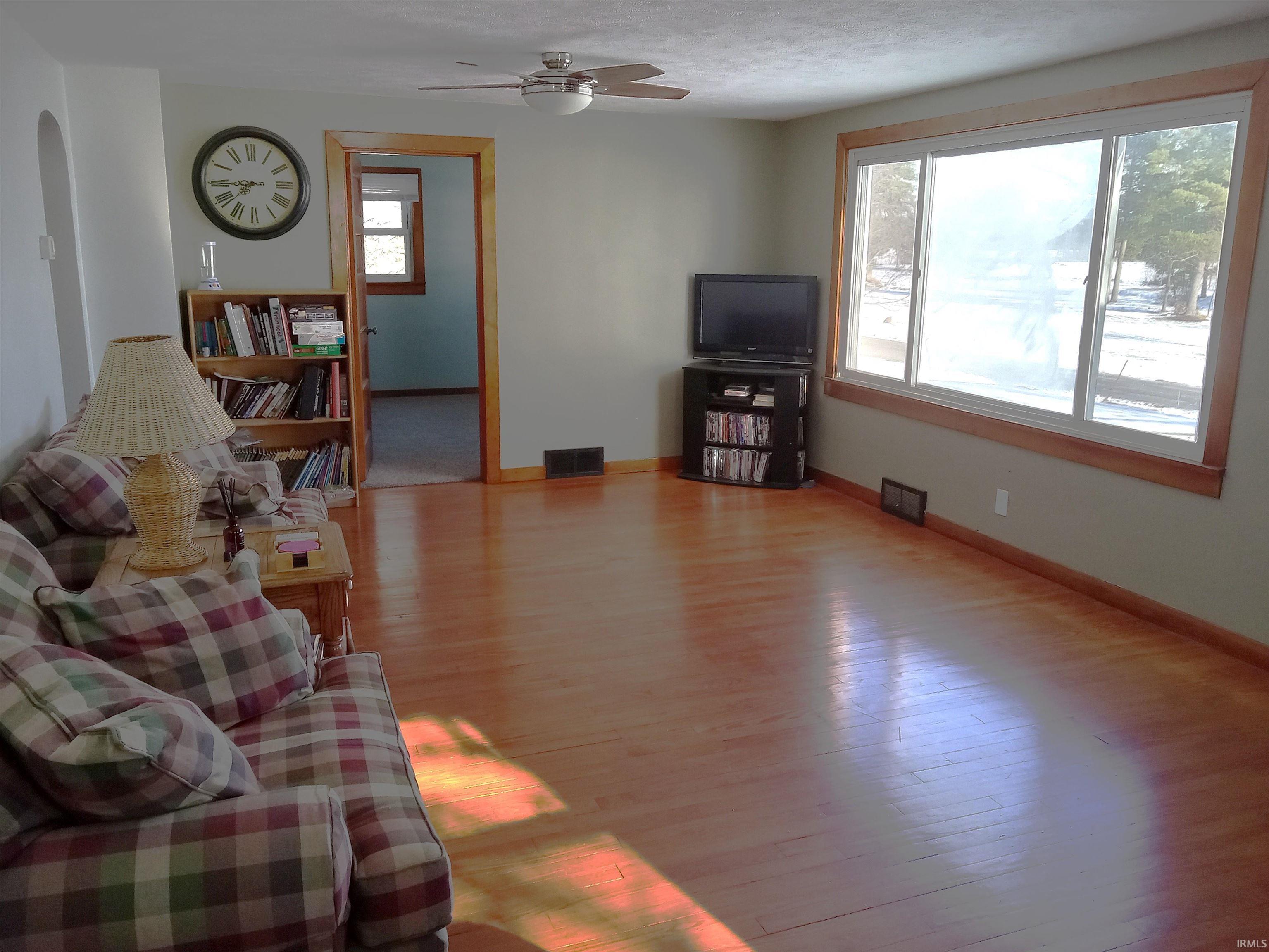 Living room featuring ceiling fan and light wood-type flooring
