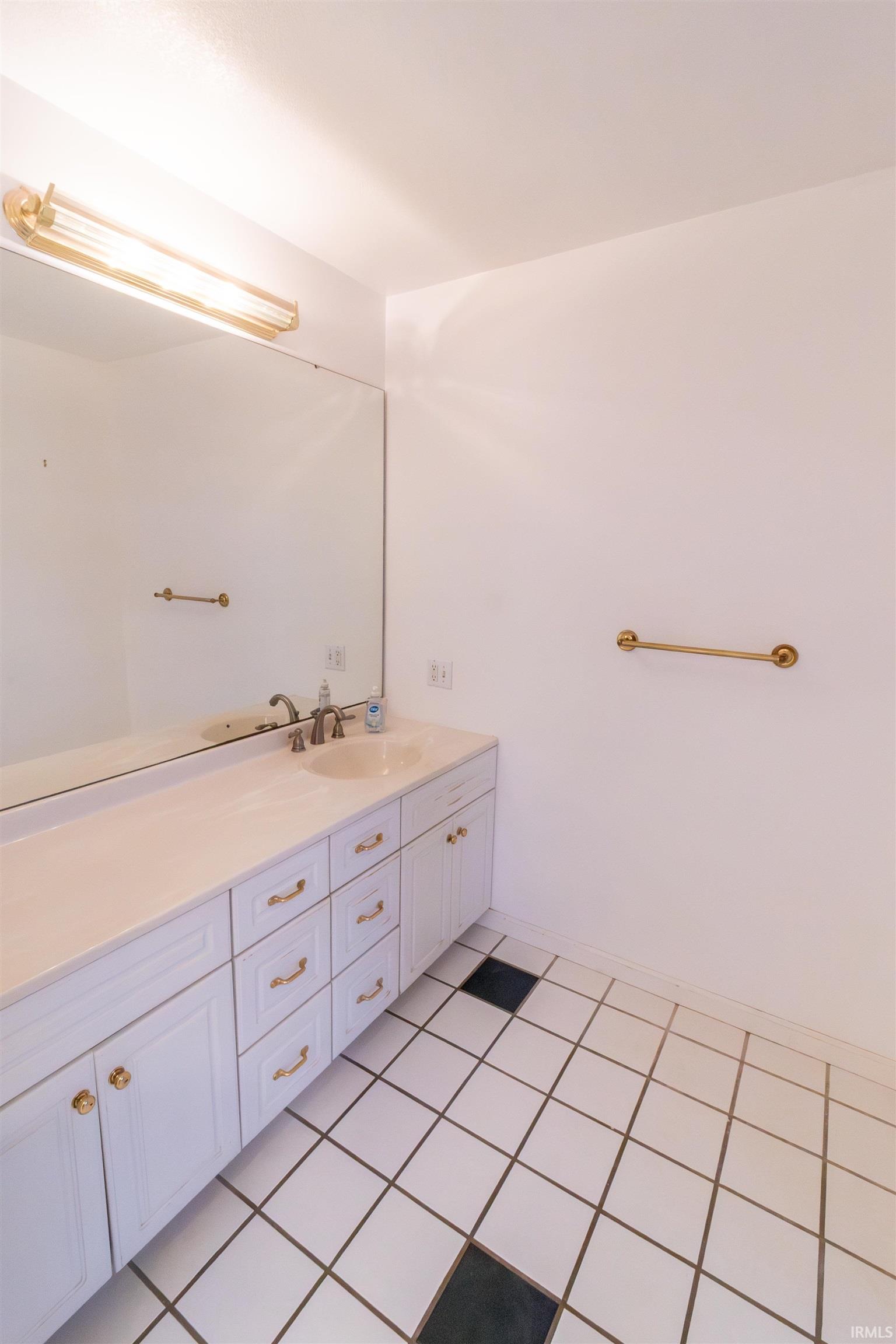 Bathroom featuring vanity and light tile patterned floors