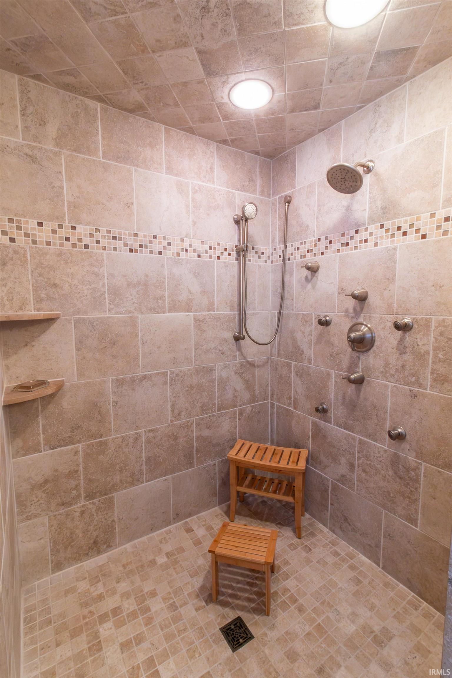 Bathroom featuring tiled shower and recessed lighting