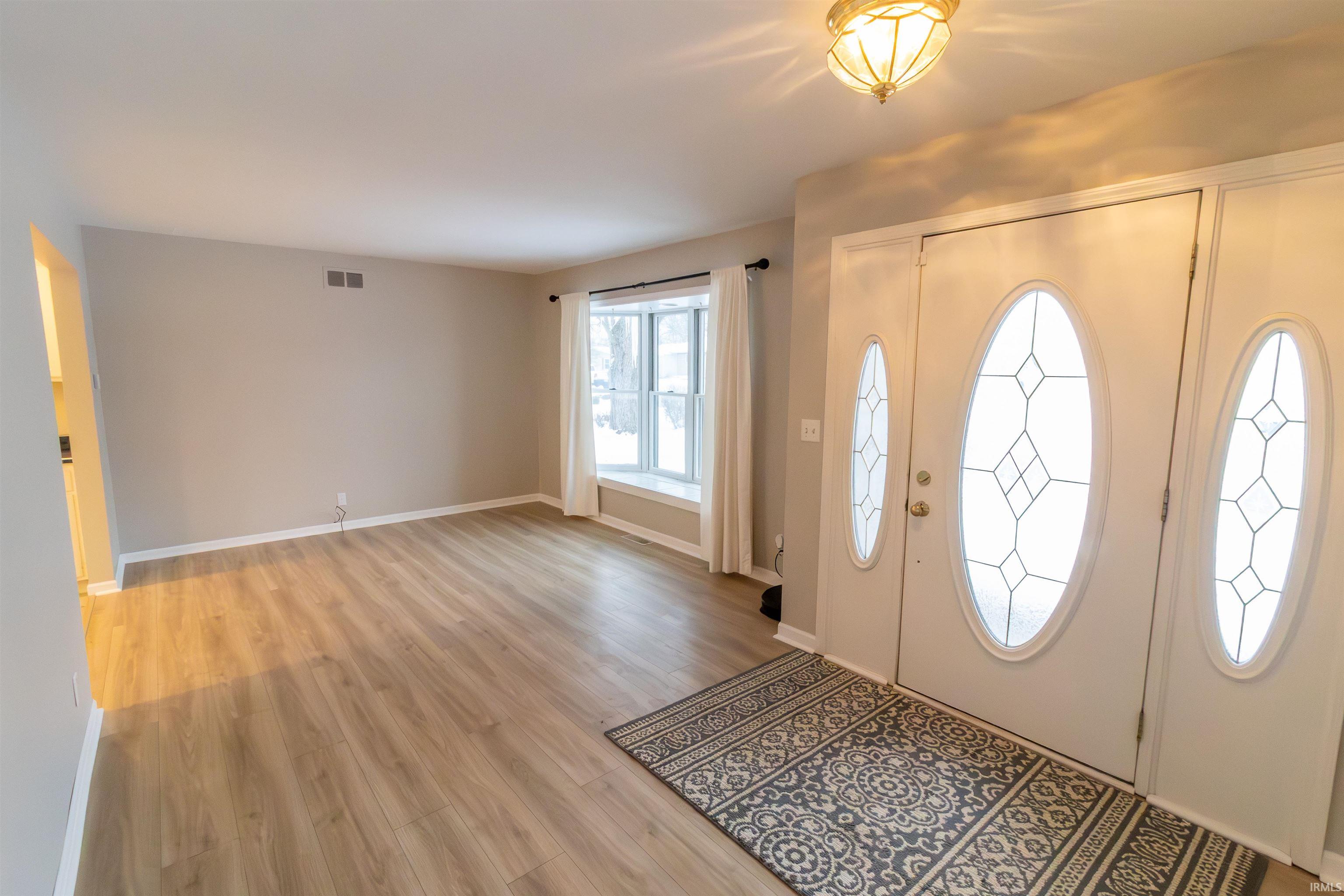 Entryway featuring light wood-style flooring and baseboards
