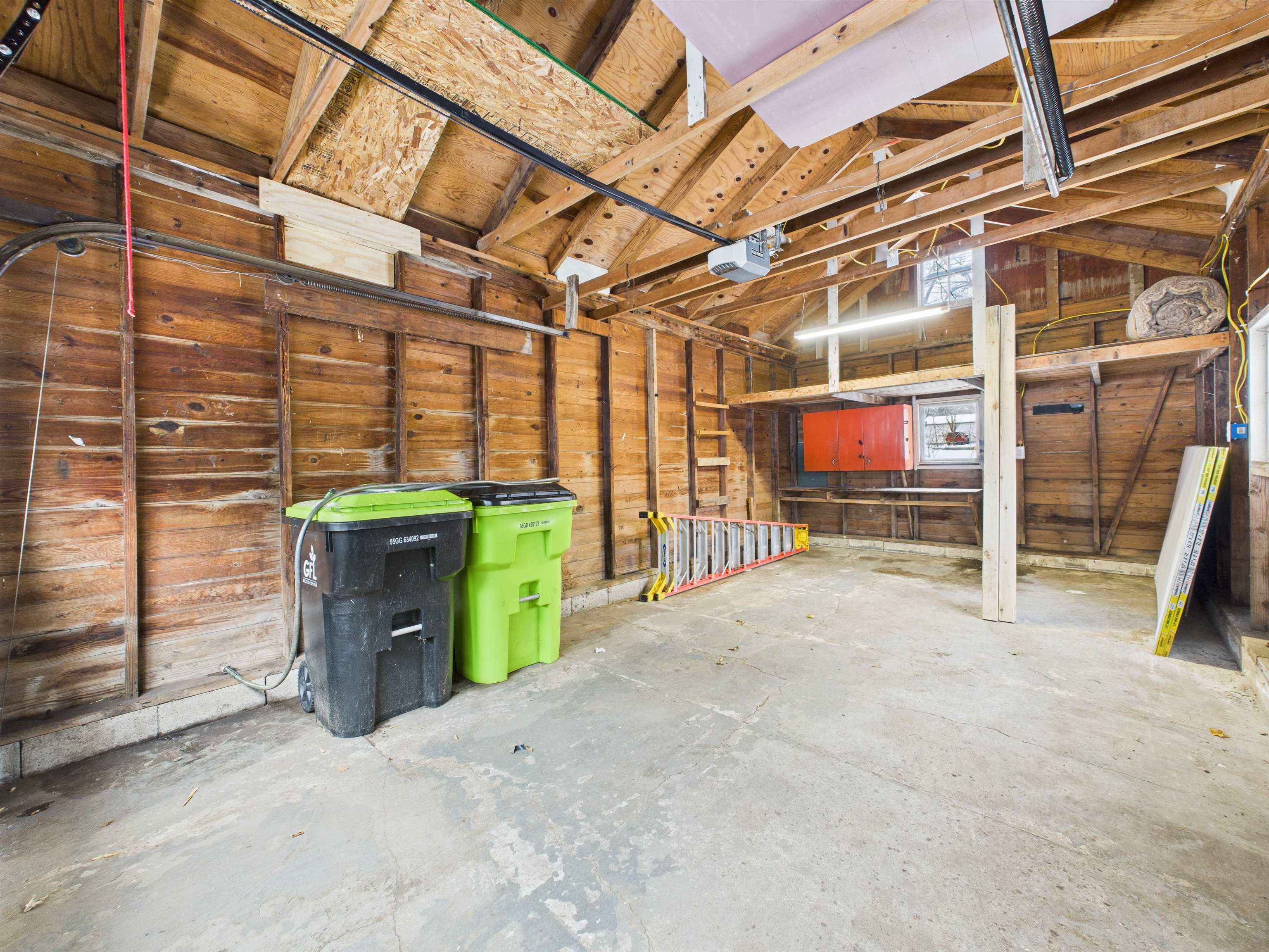 Misc room with a garage and concrete flooring