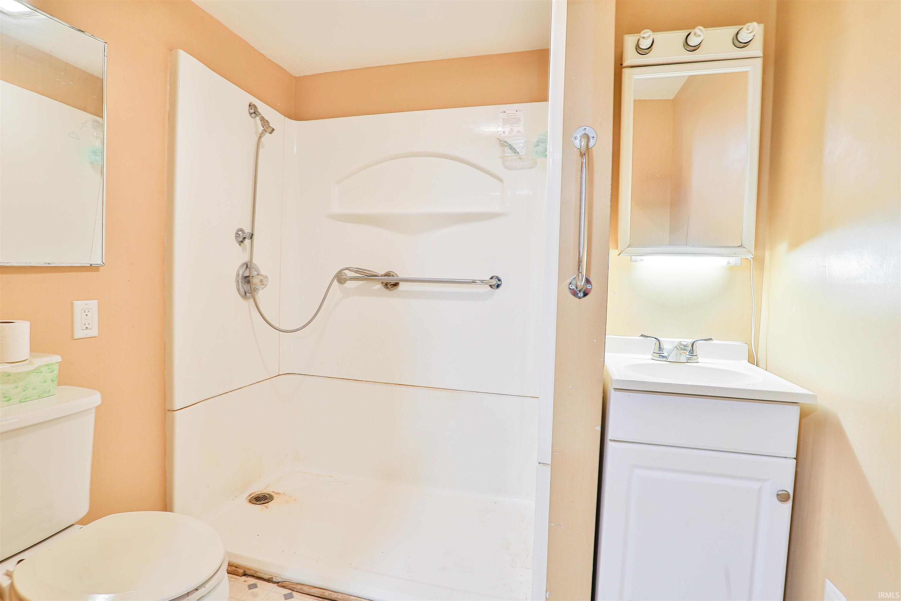 Bathroom featuring vanity and a shower