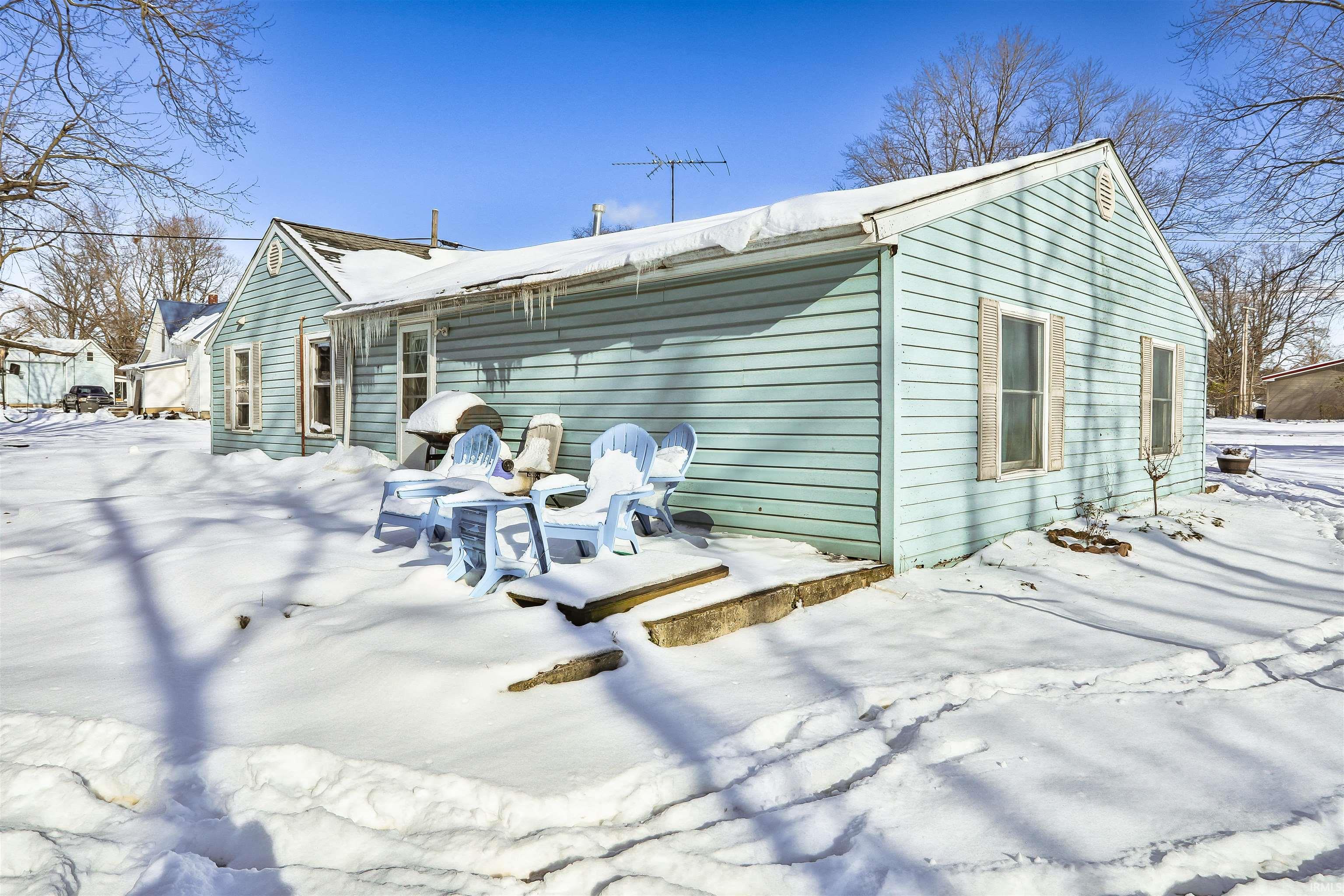 View of snow covered rear of property