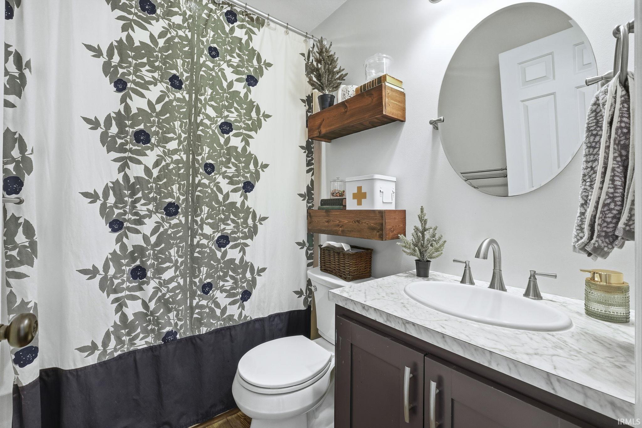 Full bathroom featuring vanity and toilet