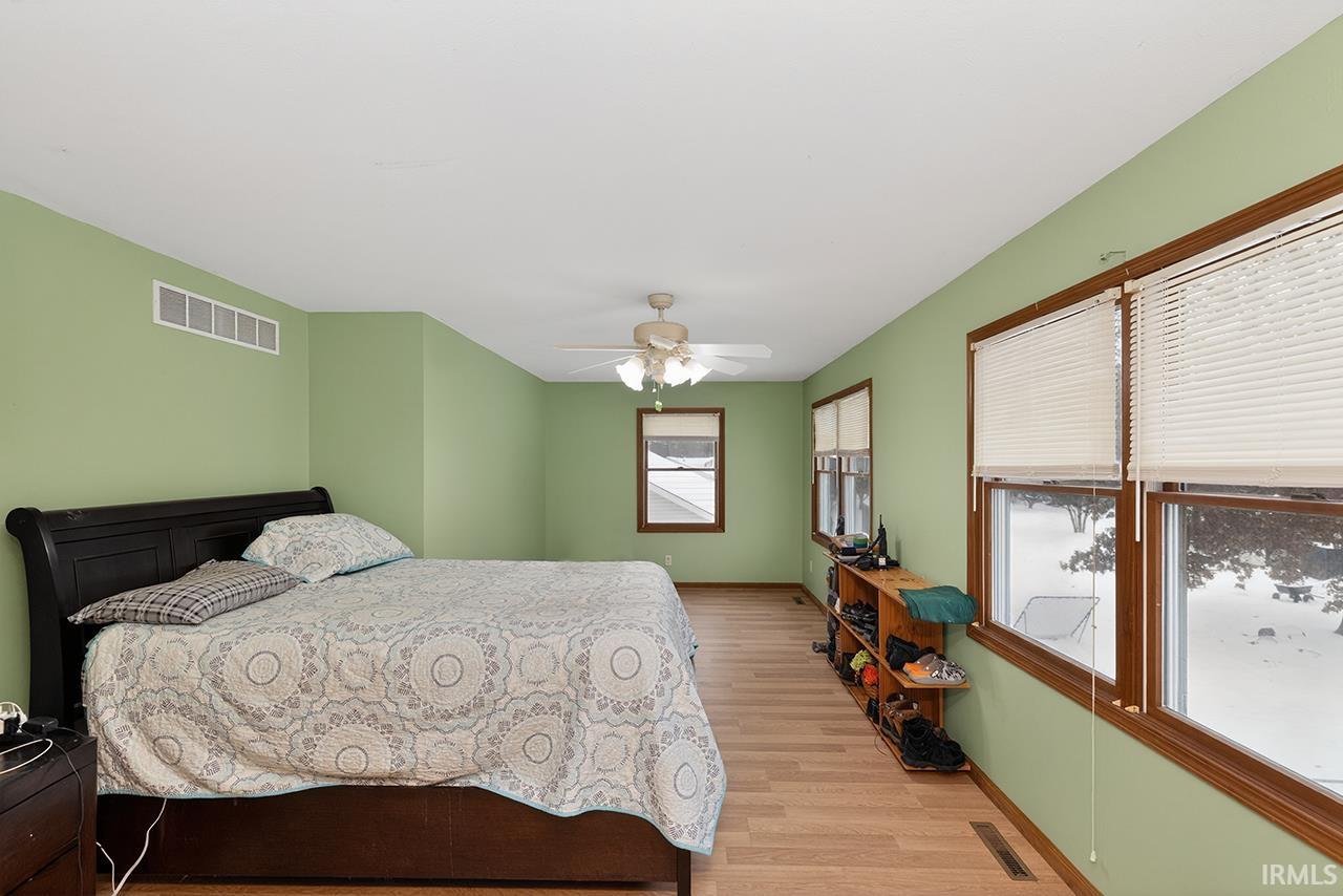 Bedroom featuring light wood-style flooring and a ceiling fan