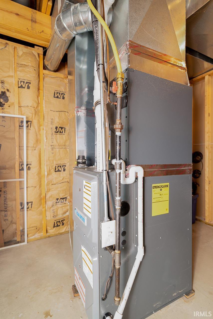 Utility room featuring heating unit