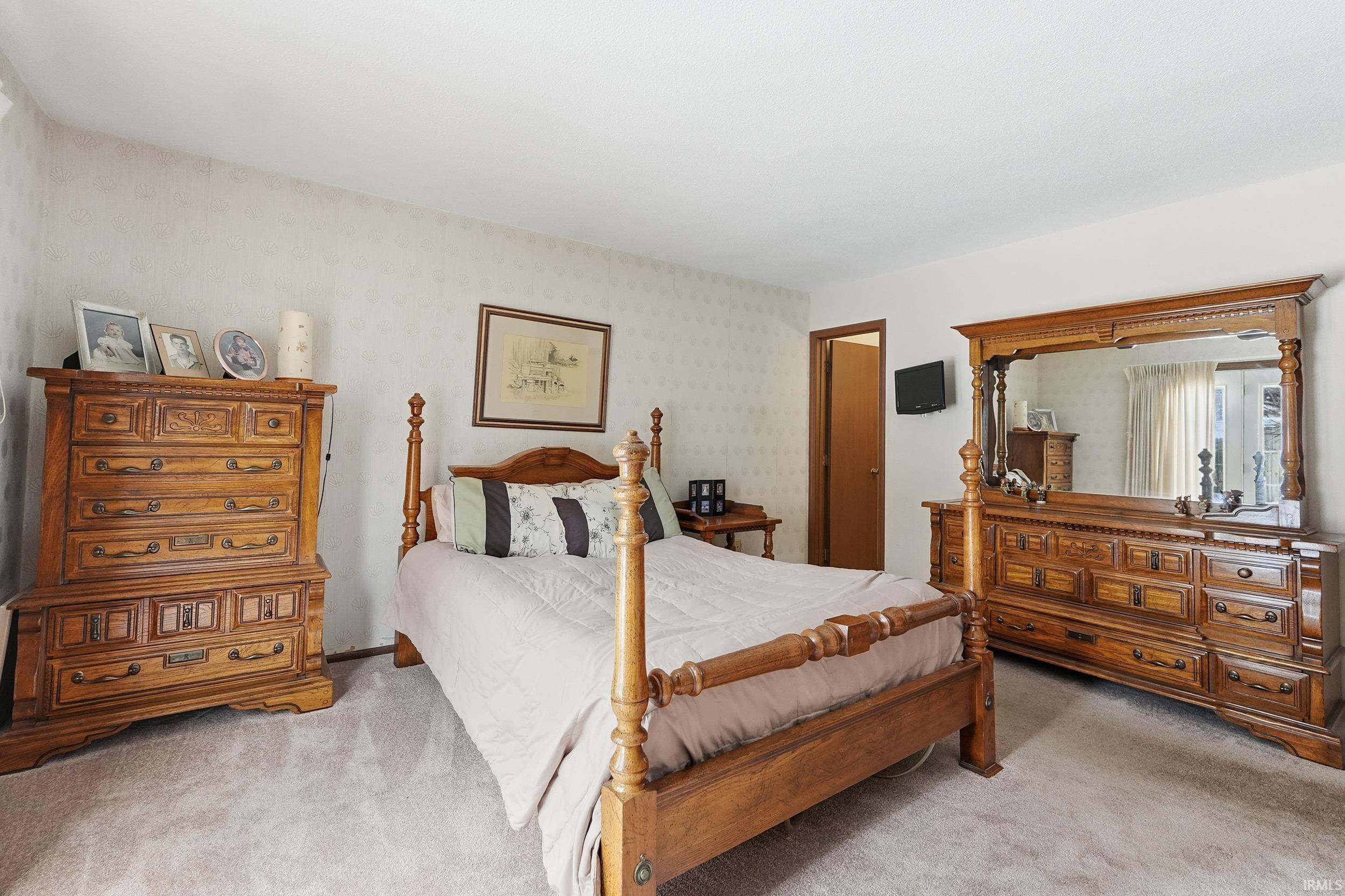 Bedroom with light colored carpet