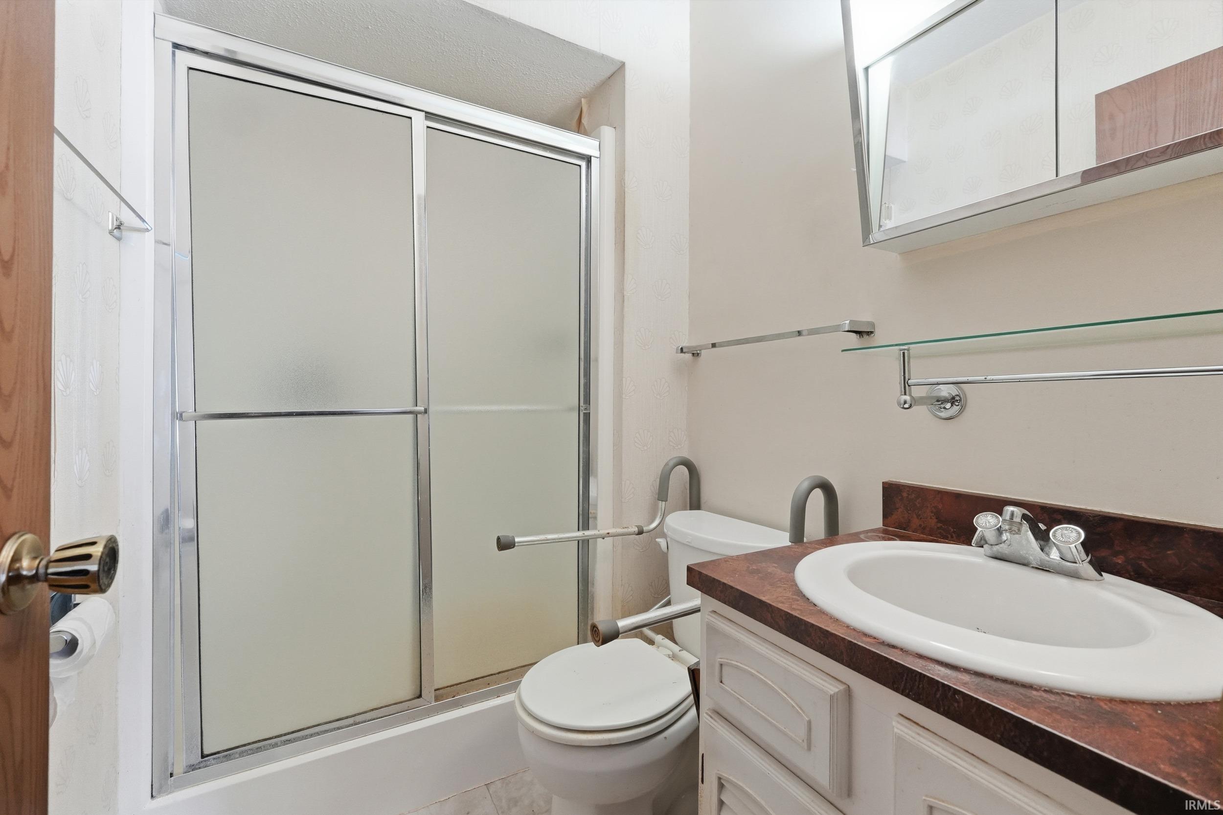 Bathroom featuring vanity and a shower stall