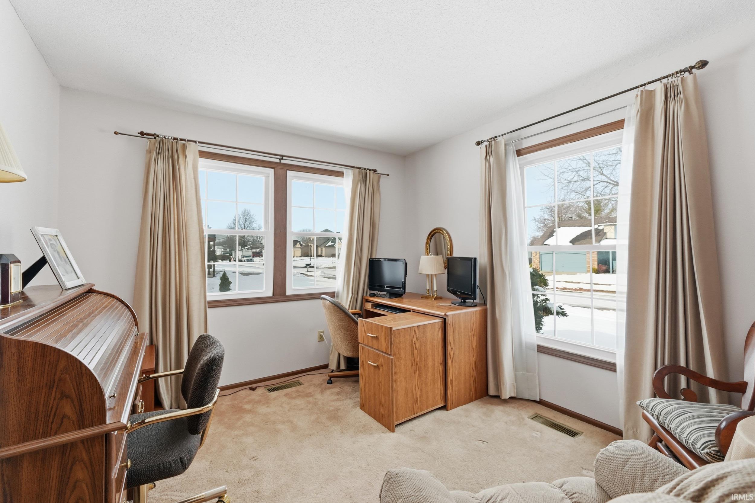 Office with carpet floors and baseboards