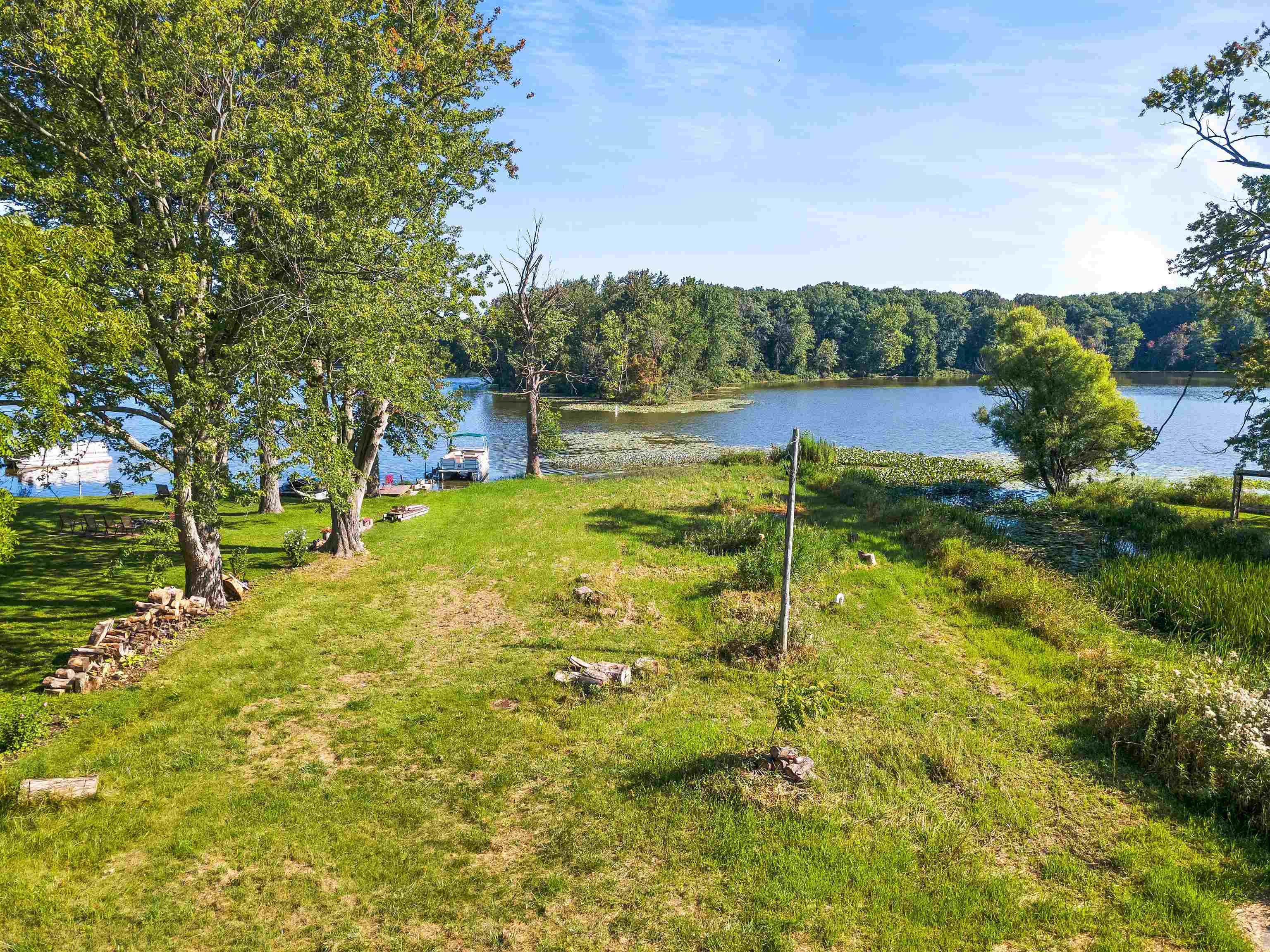 View of grassy yard with a water view and a forest view