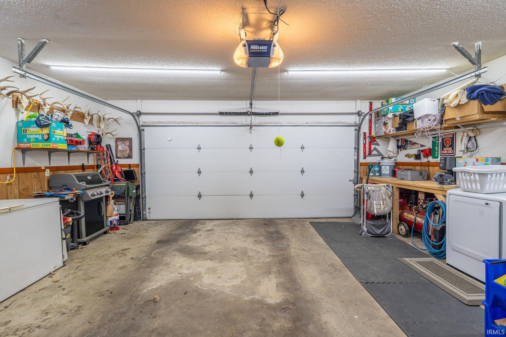Garage with washer / dryer and a garage door opener
