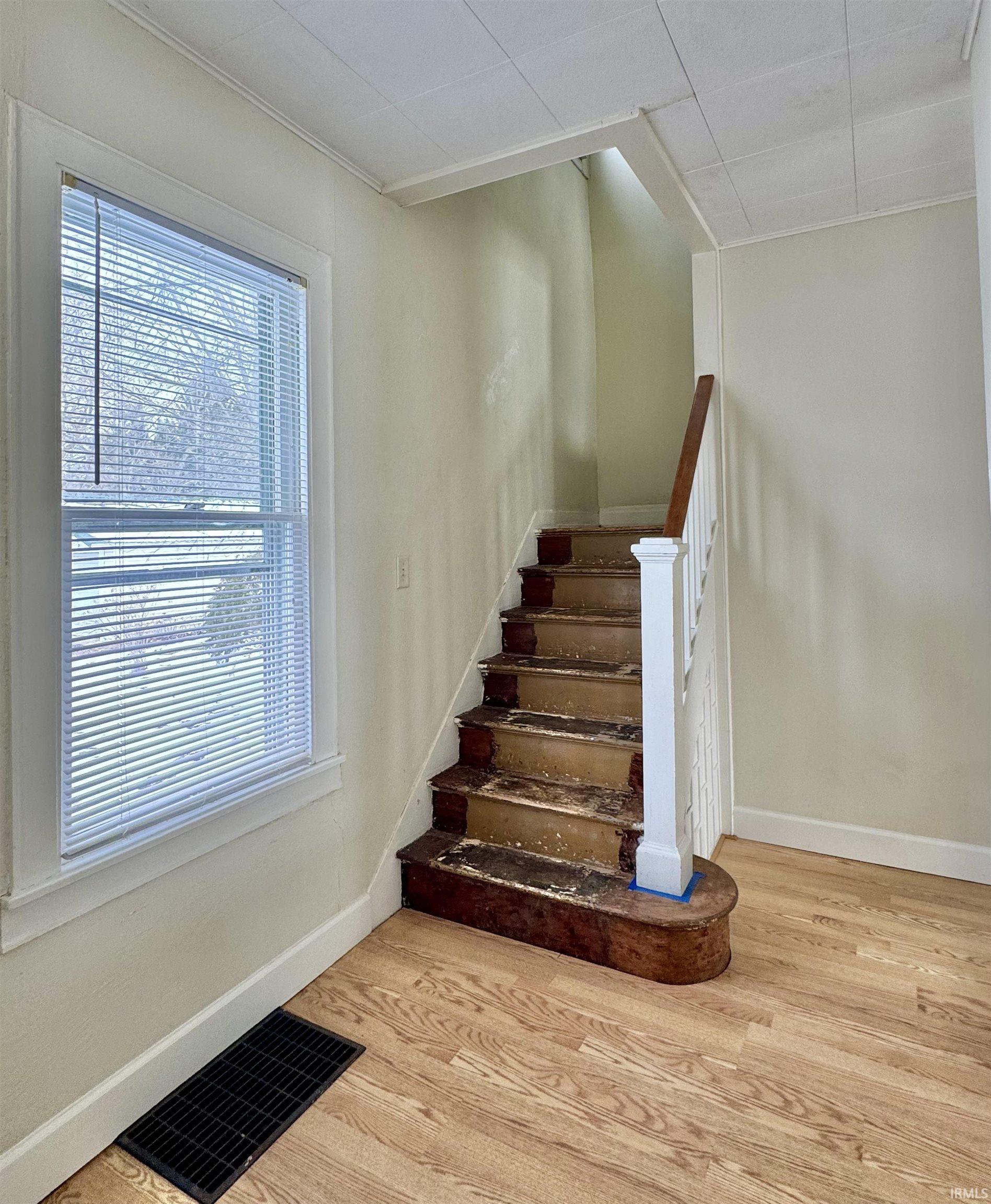 Staircase featuring wood finished floors