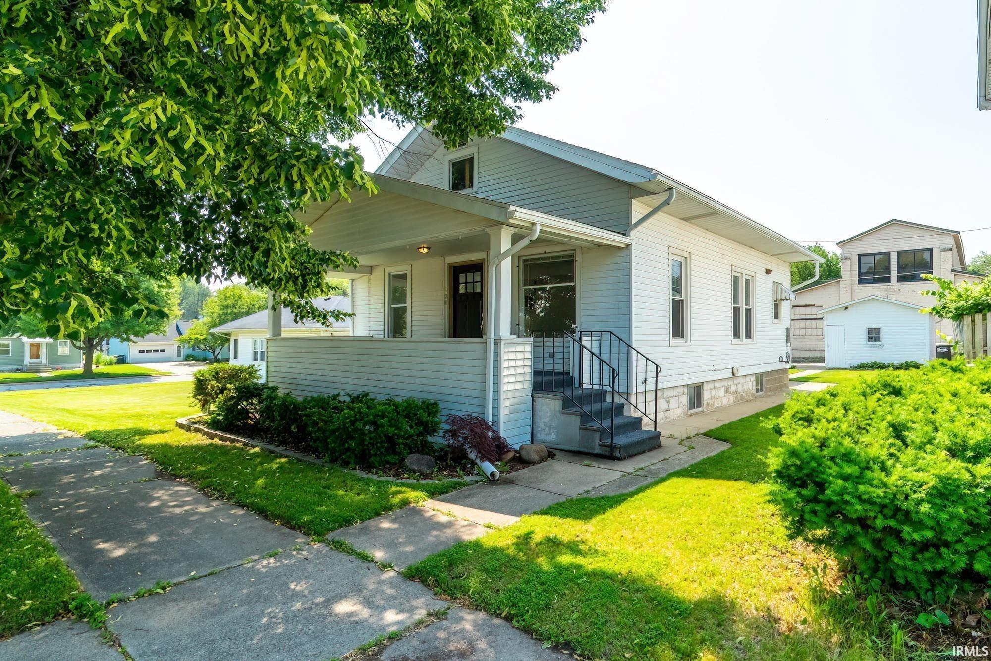 View of front facade featuring a porch and a front lawn