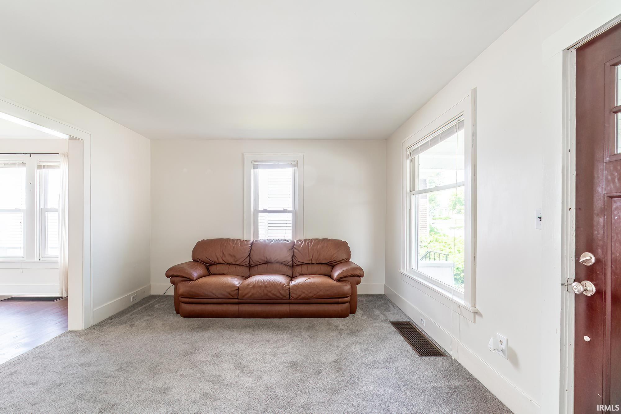 Carpeted living room with plenty of natural light