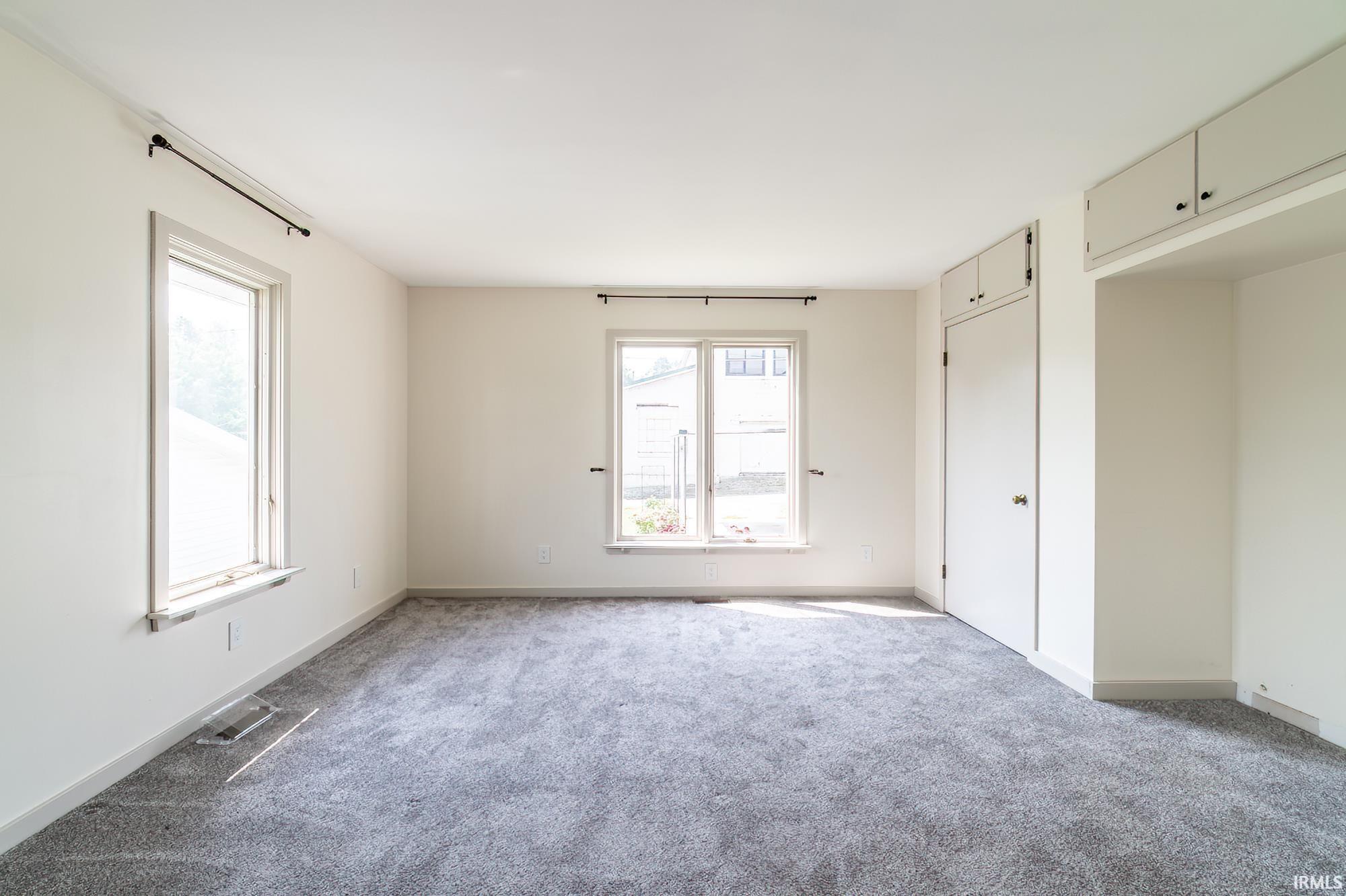 Unfurnished bedroom featuring carpet and baseboards