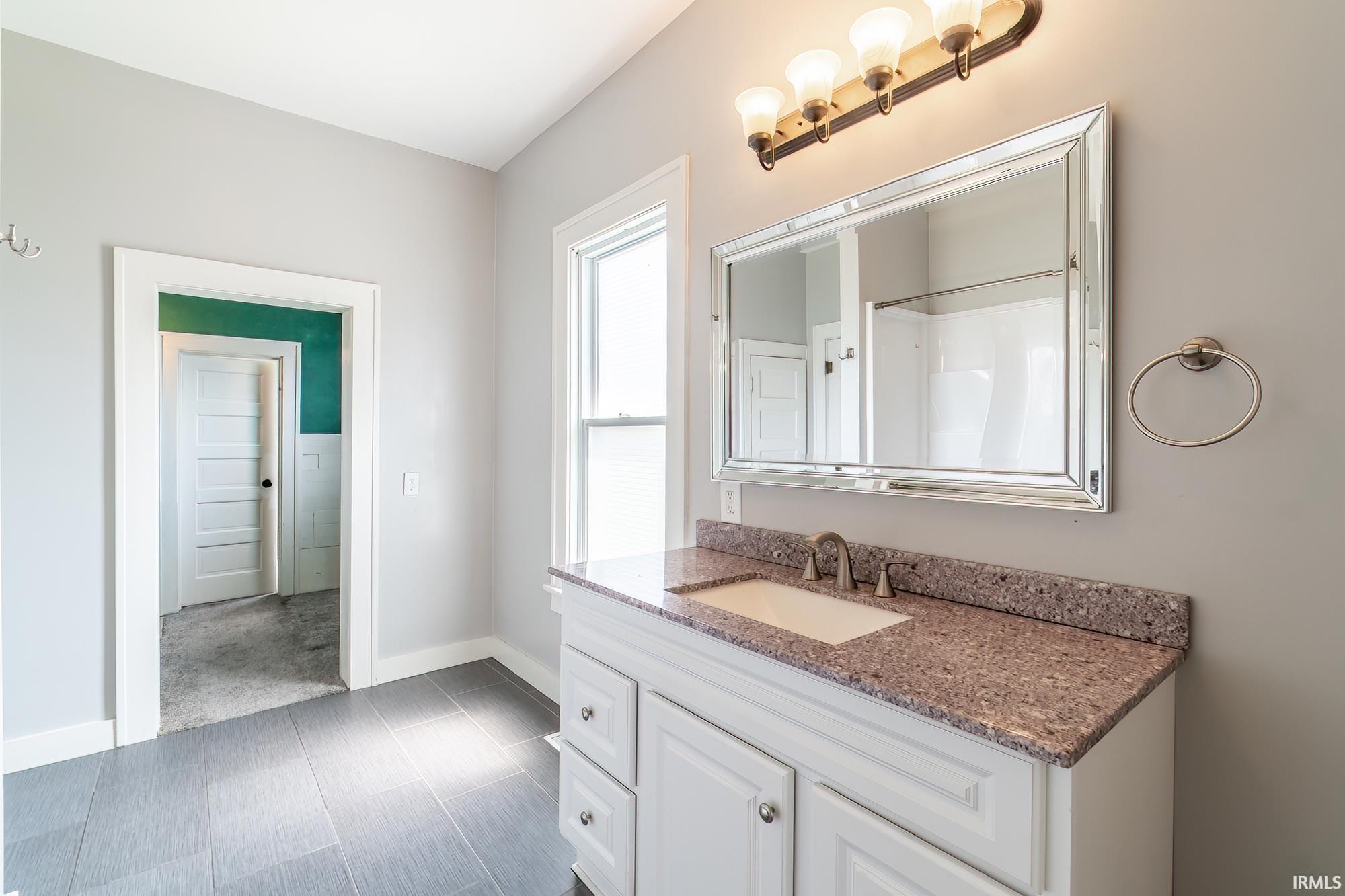Full bathroom with vanity and a shower