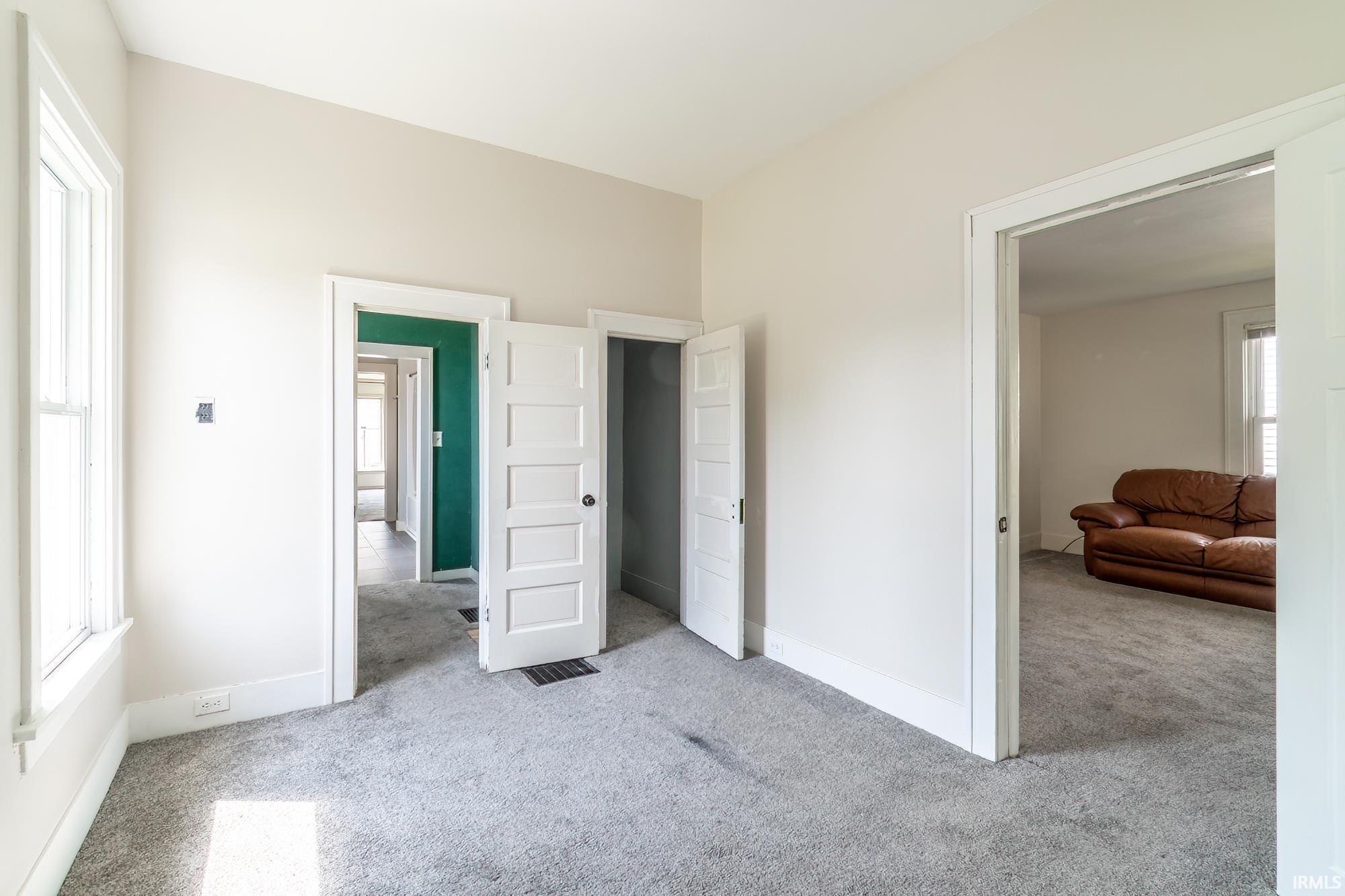 Bedroom featuring light colored carpet