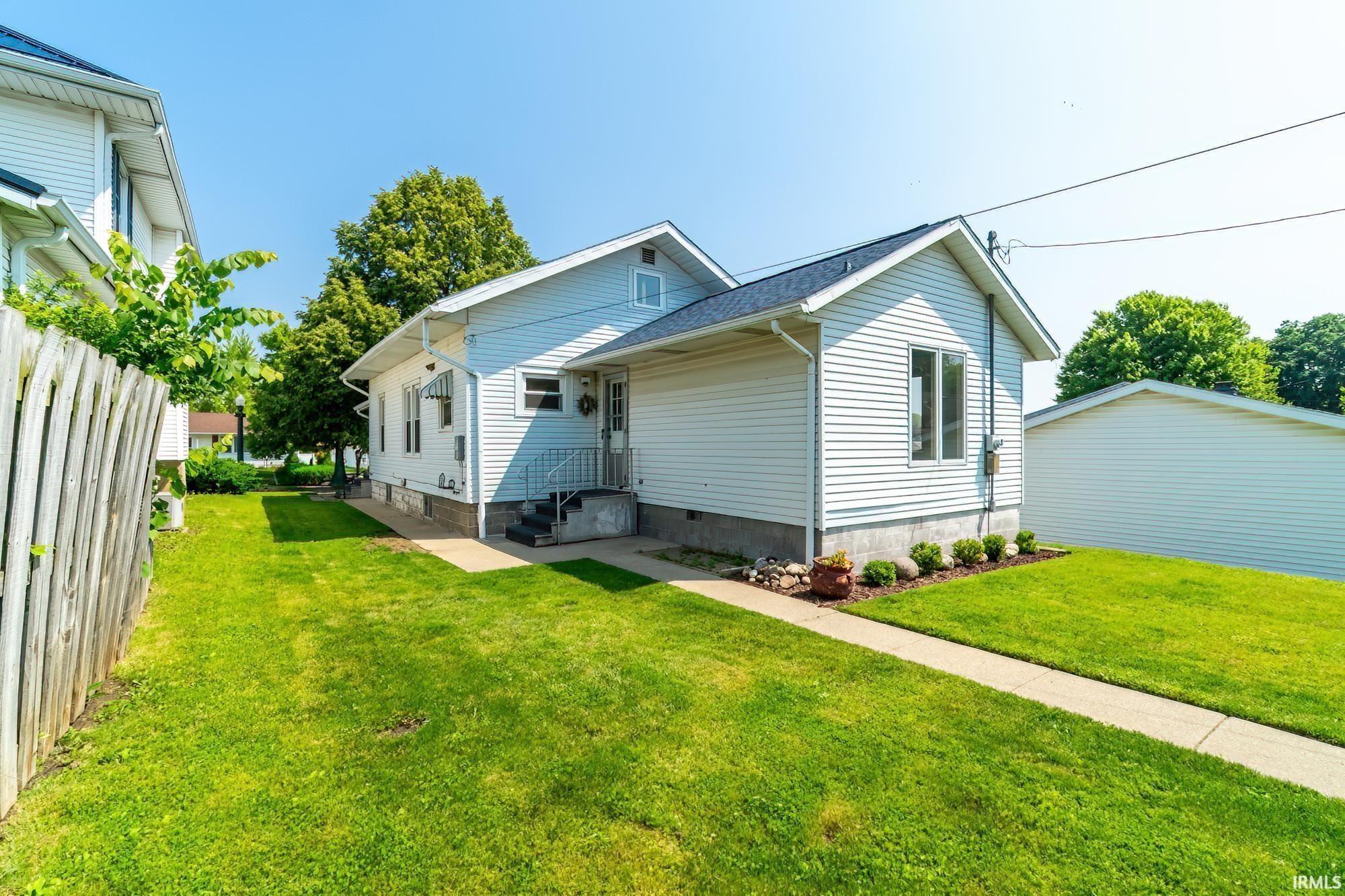 Back of property featuring a shingled roof