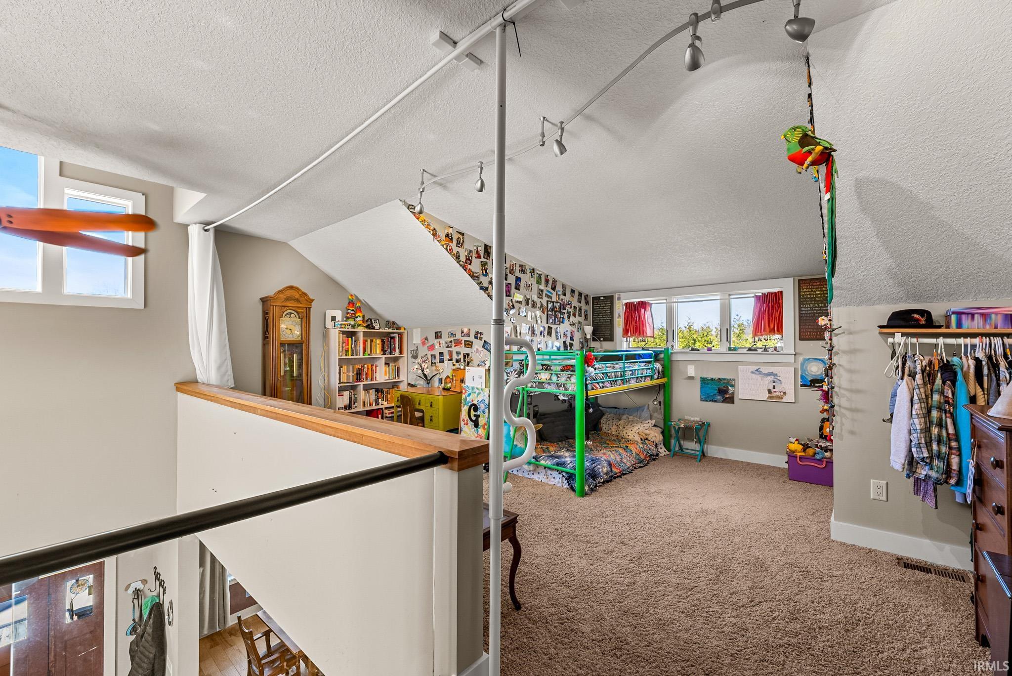 Game room with a textured ceiling and light colored carpet