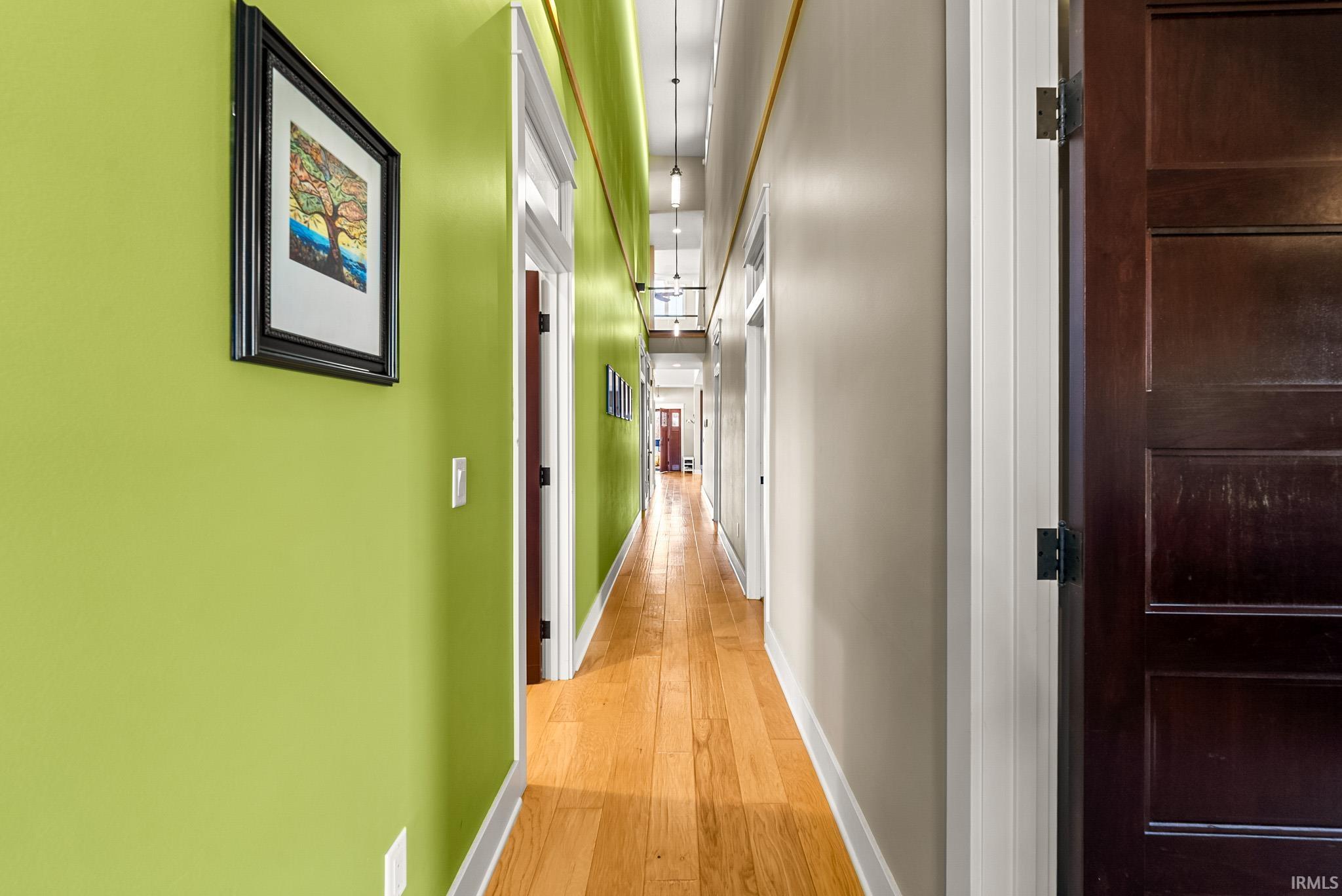 Hall featuring baseboards and light wood-type flooring