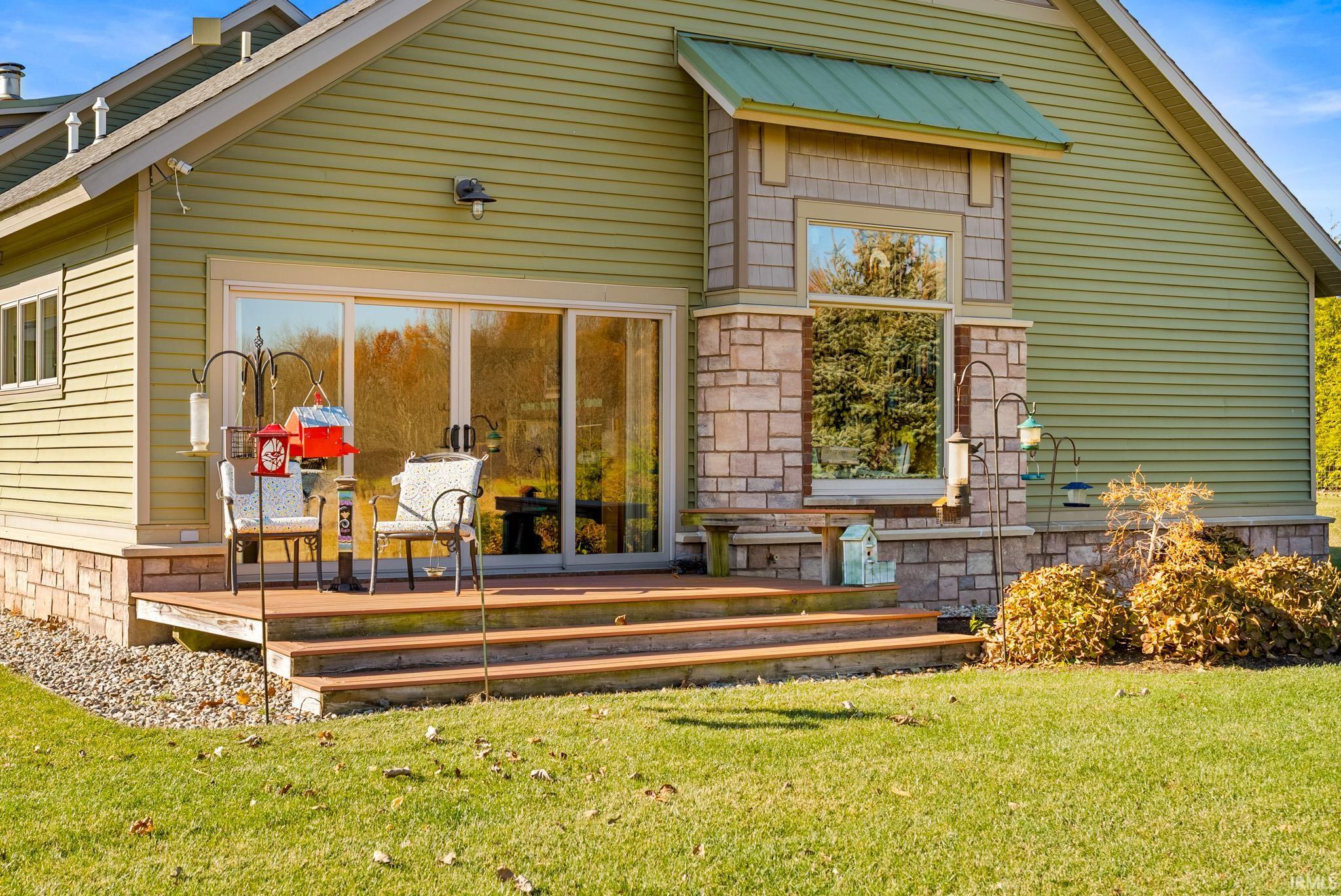 Rear view of property with a yard